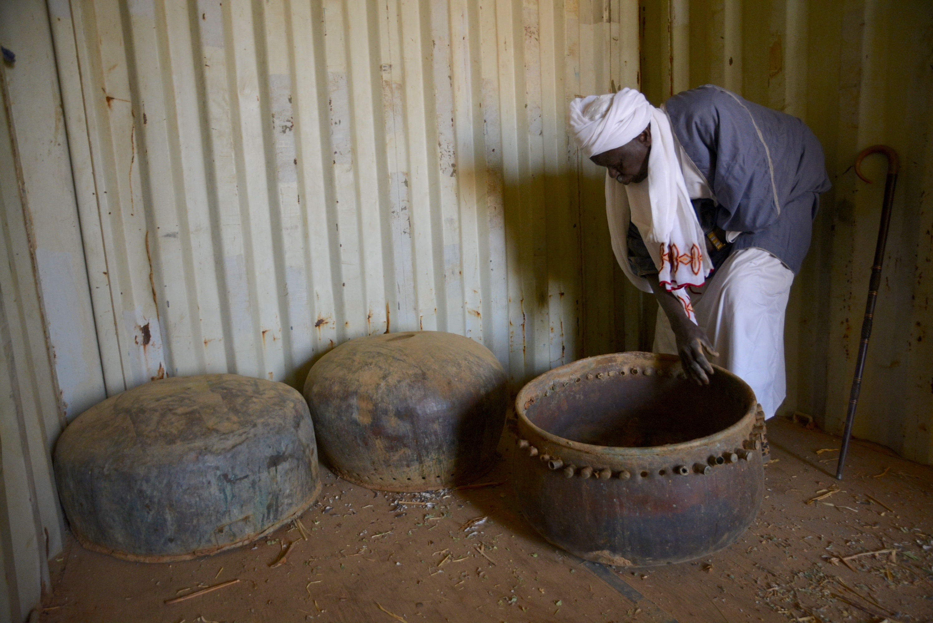 Melik Jaffar with some of the nahas (copper drums) that were damaged during the 2004 destruction of Am Boru. April 2023