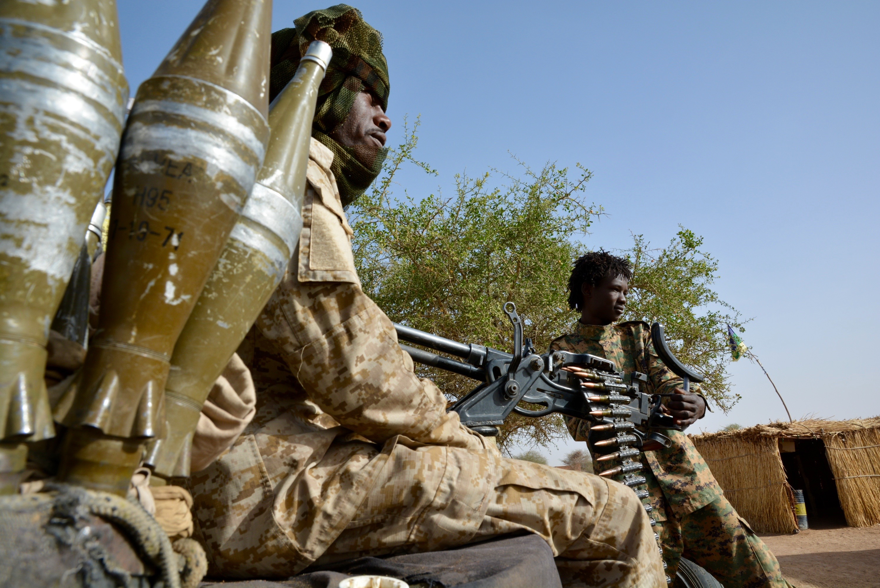 Rebel soldiers in Abu Gamra, in April 2023, with Sudan’s independence flag flying in the distance