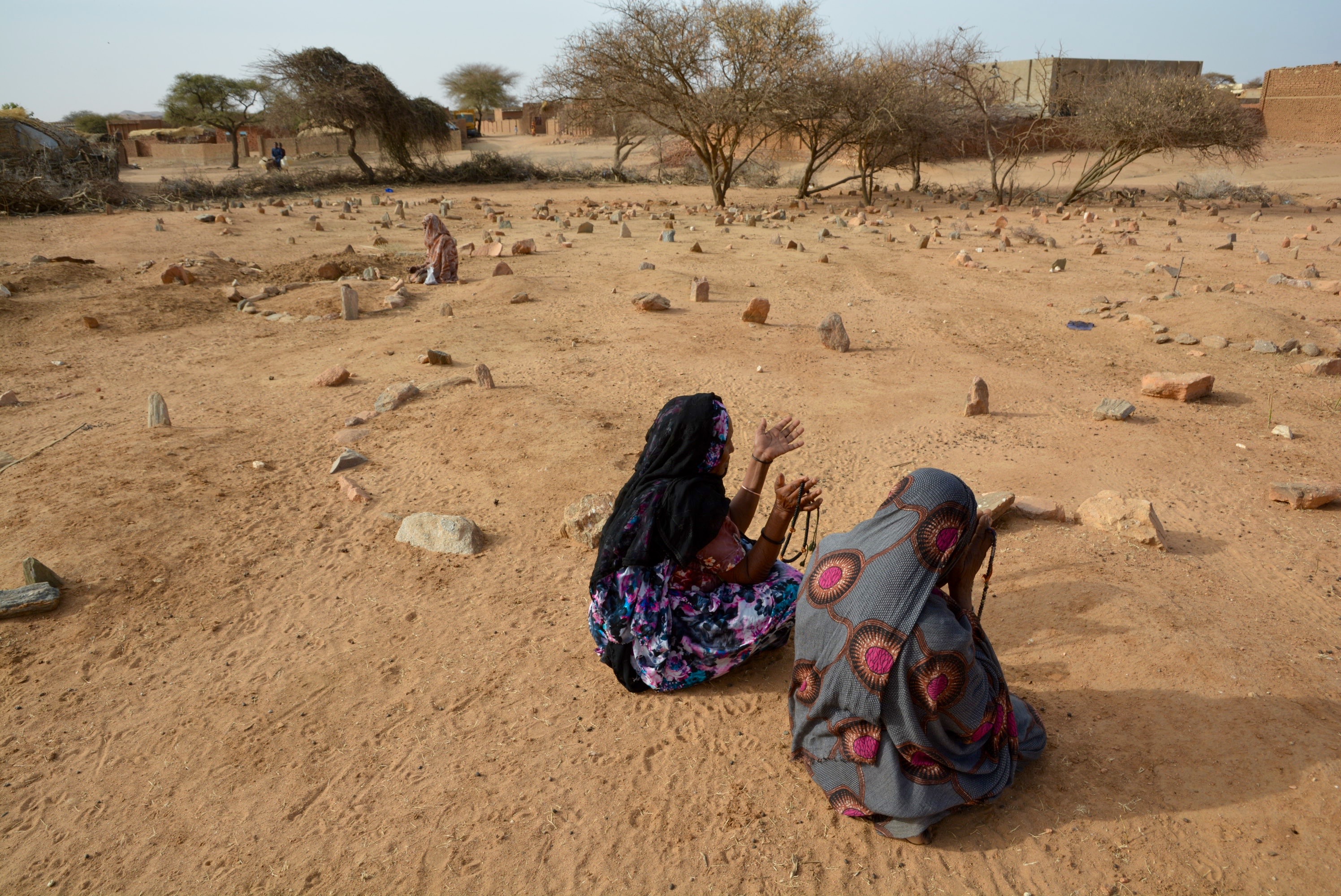 Arab women pray in the graveyard of an old Arab settlement near Kutum, North Darfur. April 2023