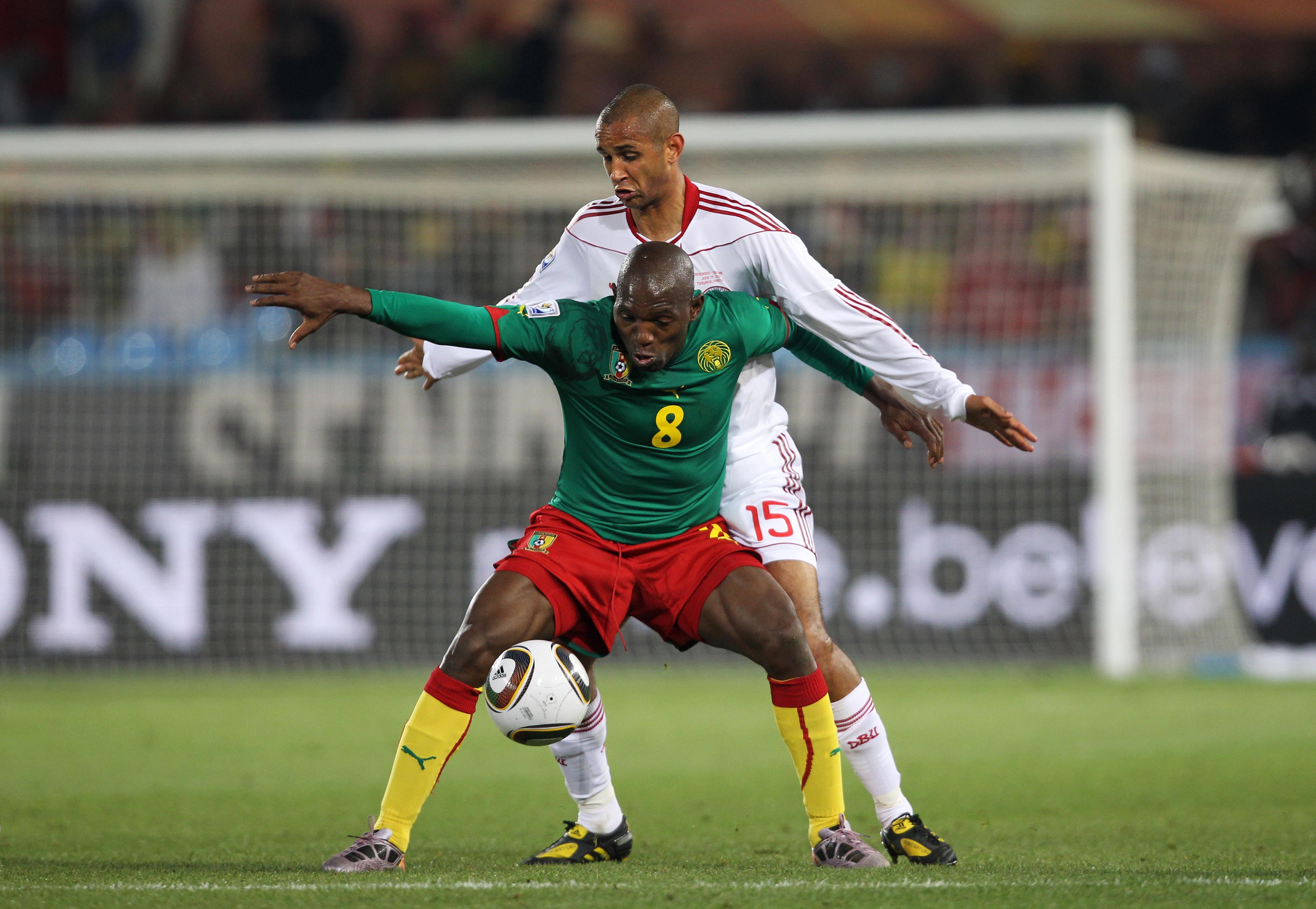 Cameroon's Geremi holds off Denmark's Simon Poulsen