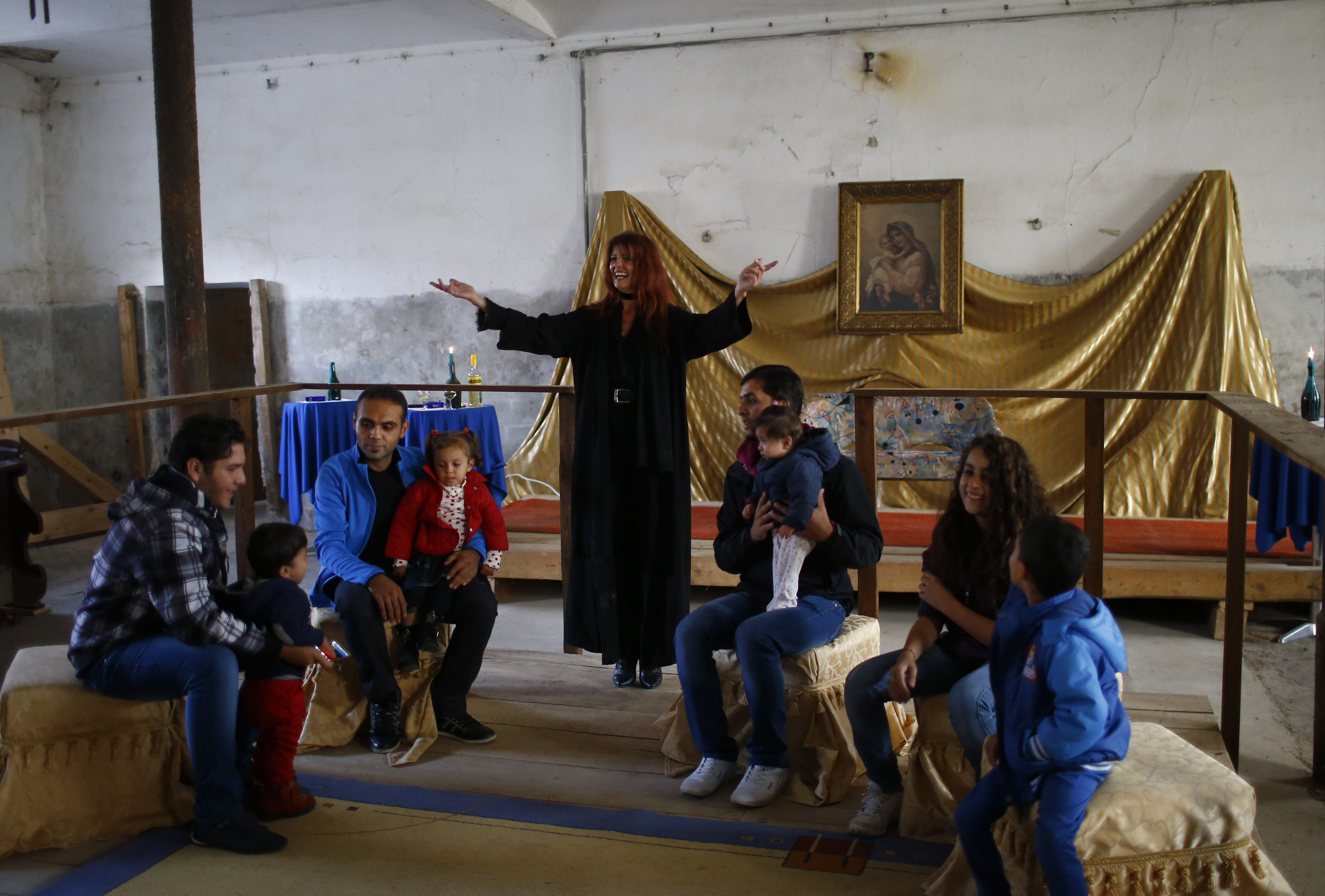 Refugees celebrate Eid al-Adha with Austrian villager Sabine Schoeller-Lamberty, centre, in the hall of Schloss Koenigshof, an ancient Habsburg castle in Bruckneudorf, Austria