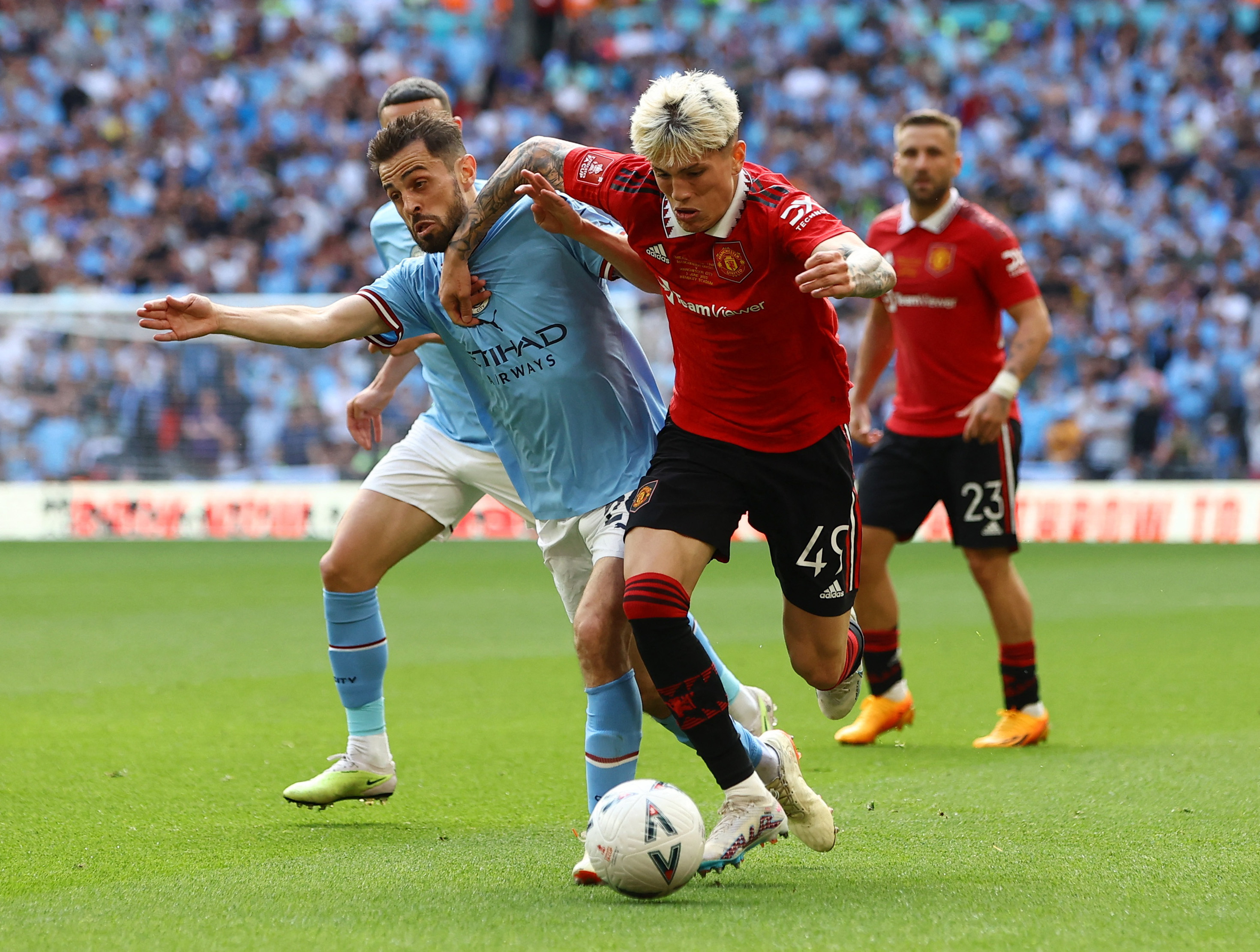 Bernardo Silva in action with Manchester United's Alejandro Garnacho