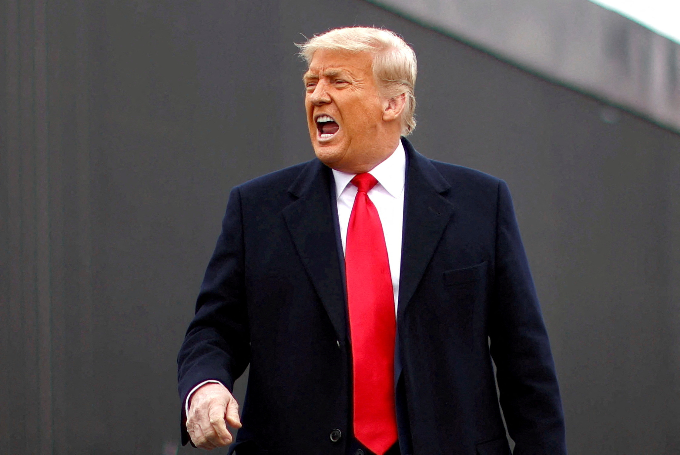 FILE PHOTO: U.S. President Donald Trump yells as he visits the U.S.-Mexico border wall, in Alamo, Texas, U.S., January 12, 2021. REUTERS/Carlos Barria/File Photo