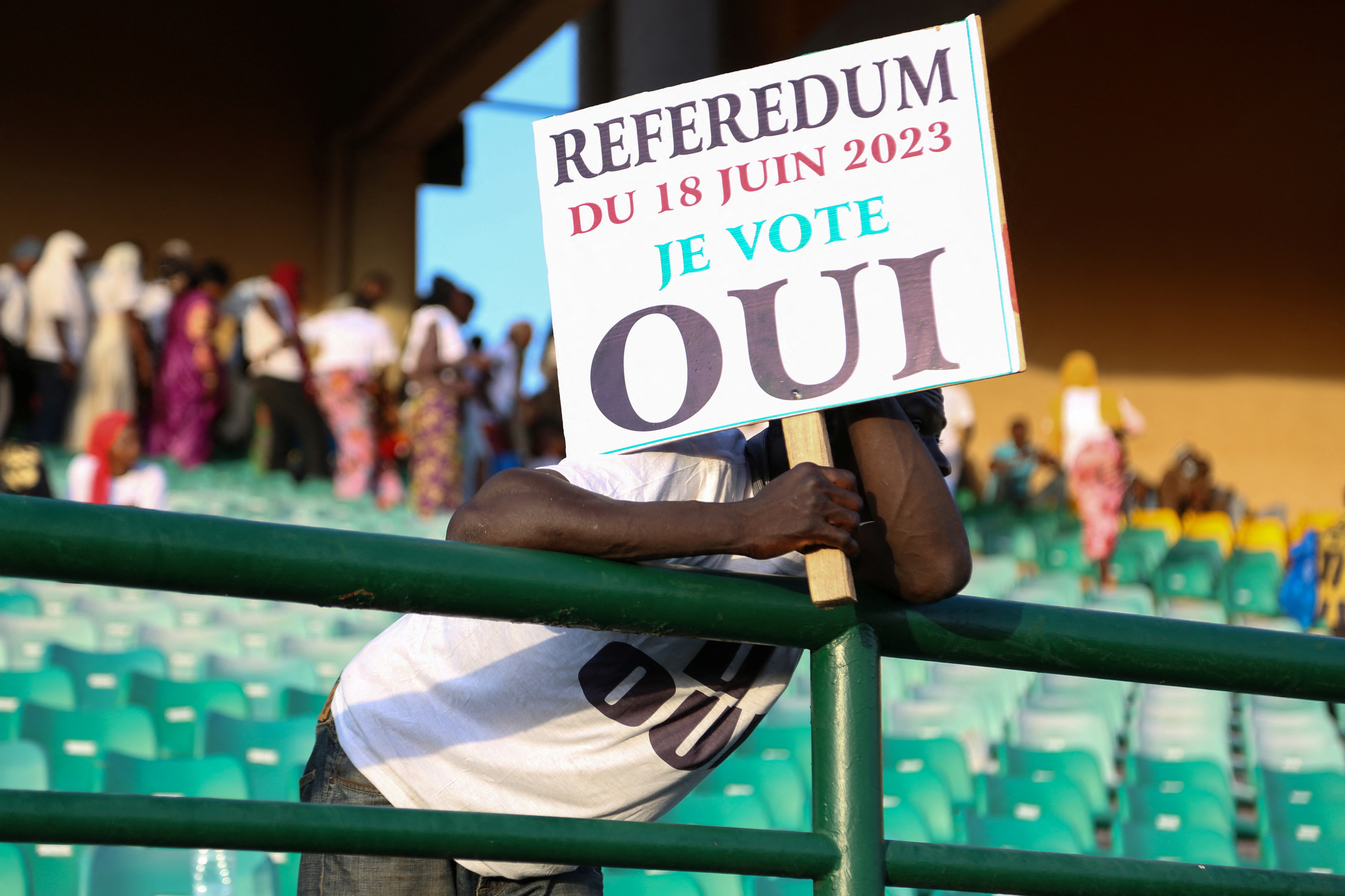A man hold a sign as he attends the last campaign rally of the ‘Yes’ group for the referendum on constitutional amendments, in Bamako, Mali