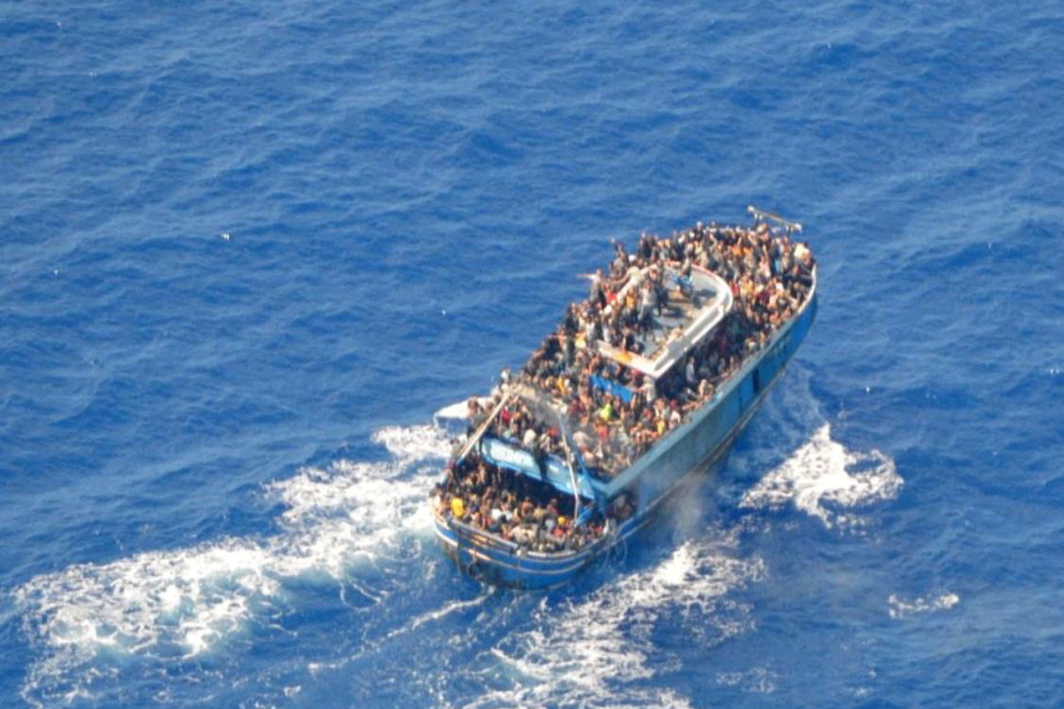 FILE PHOTO: A undated handout photo provided by the Hellenic Coast Guard shows migrants onboard a boat during a rescue operation, before their boat capsized on the open sea, off Greece, June 14, 2023. Hellenic Coast Guard/Handout via REUTERS ATTENTION EDITORS - THIS IMAGE HAS BEEN SUPPLIED BY A THIRD PARTY. TPX IMAGES OF THE DAY/File Photo