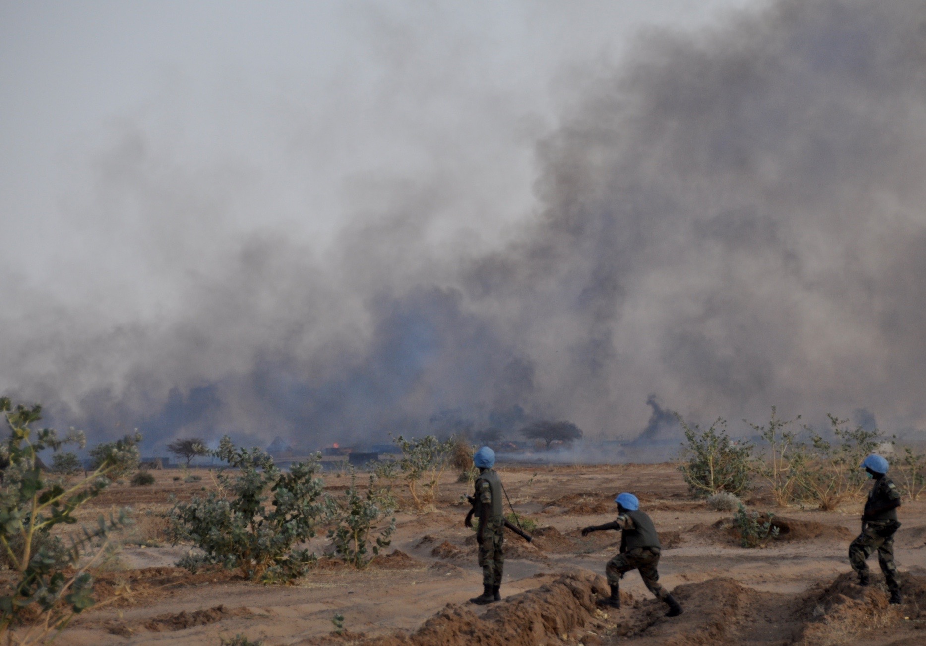 On their way back to their base, peacekeepers from Rwanda looked on at the flames engulfing a non-Arab village in North Darfur, in 2011