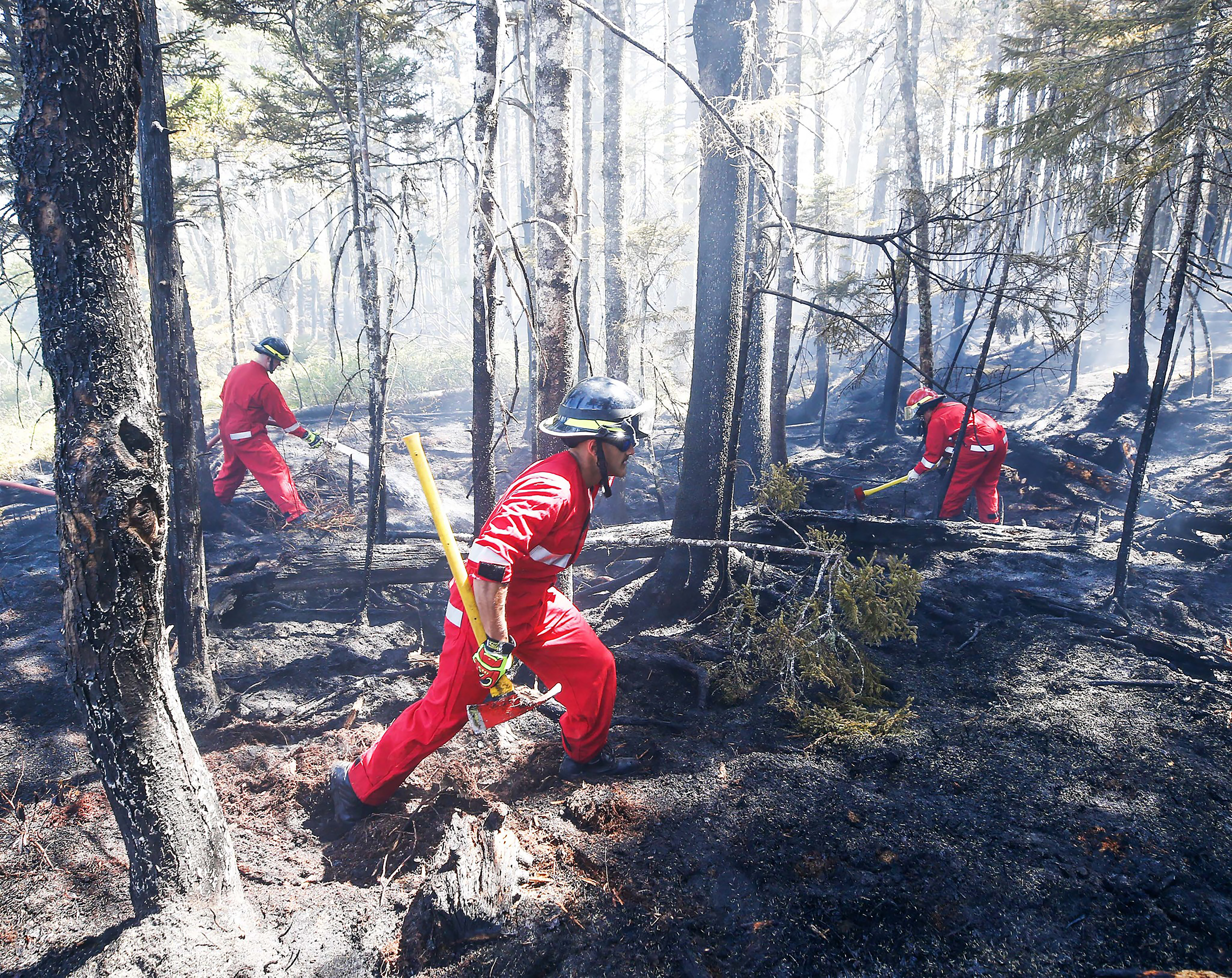 firefighters with Halifax Regional Fire and Emergency work to put out fires in the Tantallon area
