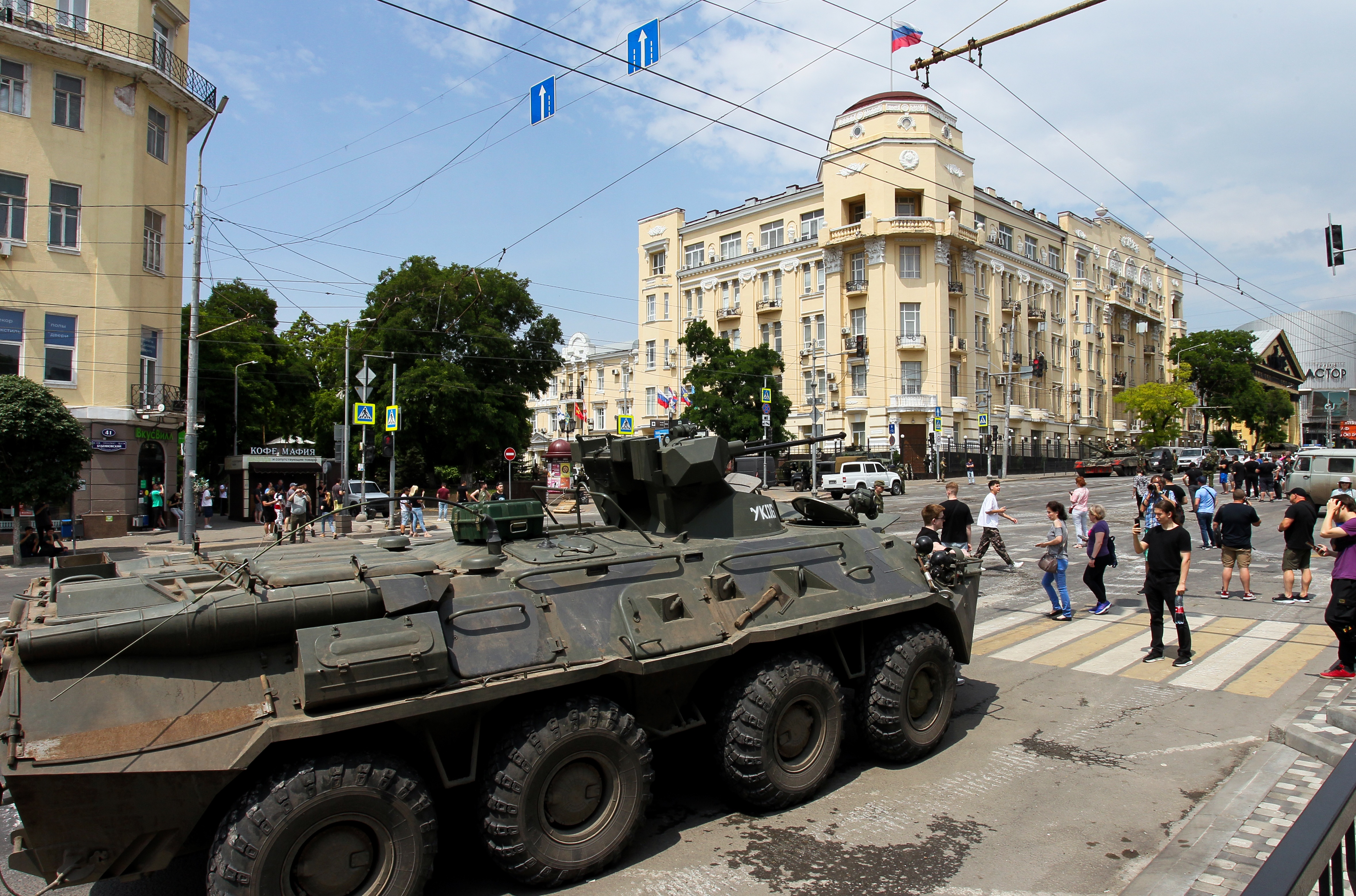 People walk past an armoured personnel carrier in the city of Rostov-on-Don