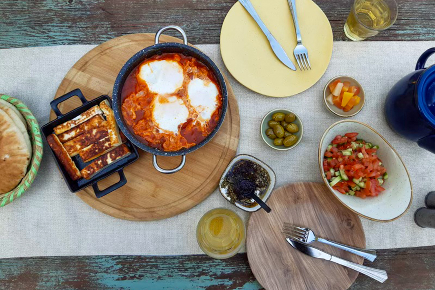 Breakfast spread with shakshouka, olives, etc