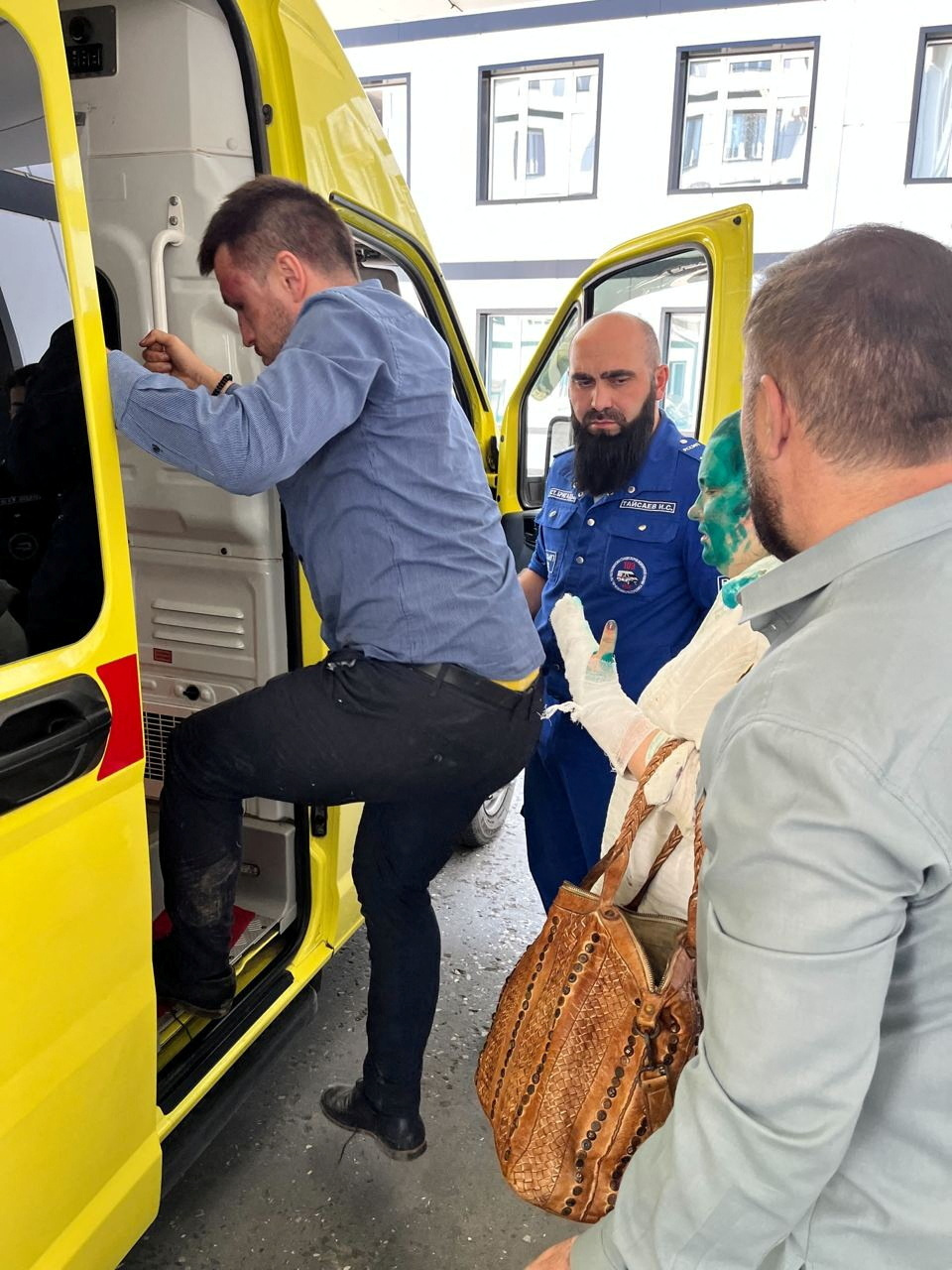 Lawyer Alexander Nemov and Yelena Milashina, a journalist for the now-banned independent newspaper Novaya Gazeta, get into an ambulance at the hospital after they were attacked on their way to the Chechen capital Grozny from the local airport, in Grozny, Russia July 4, 2023. Crew Against Torture/Handout via REUTERS ATTENTION EDITORS - THIS IMAGE WAS PROVIDED BY A THIRD PARTY. NO RESALES. NO ARCHIVES. MANDATORY CREDIT.