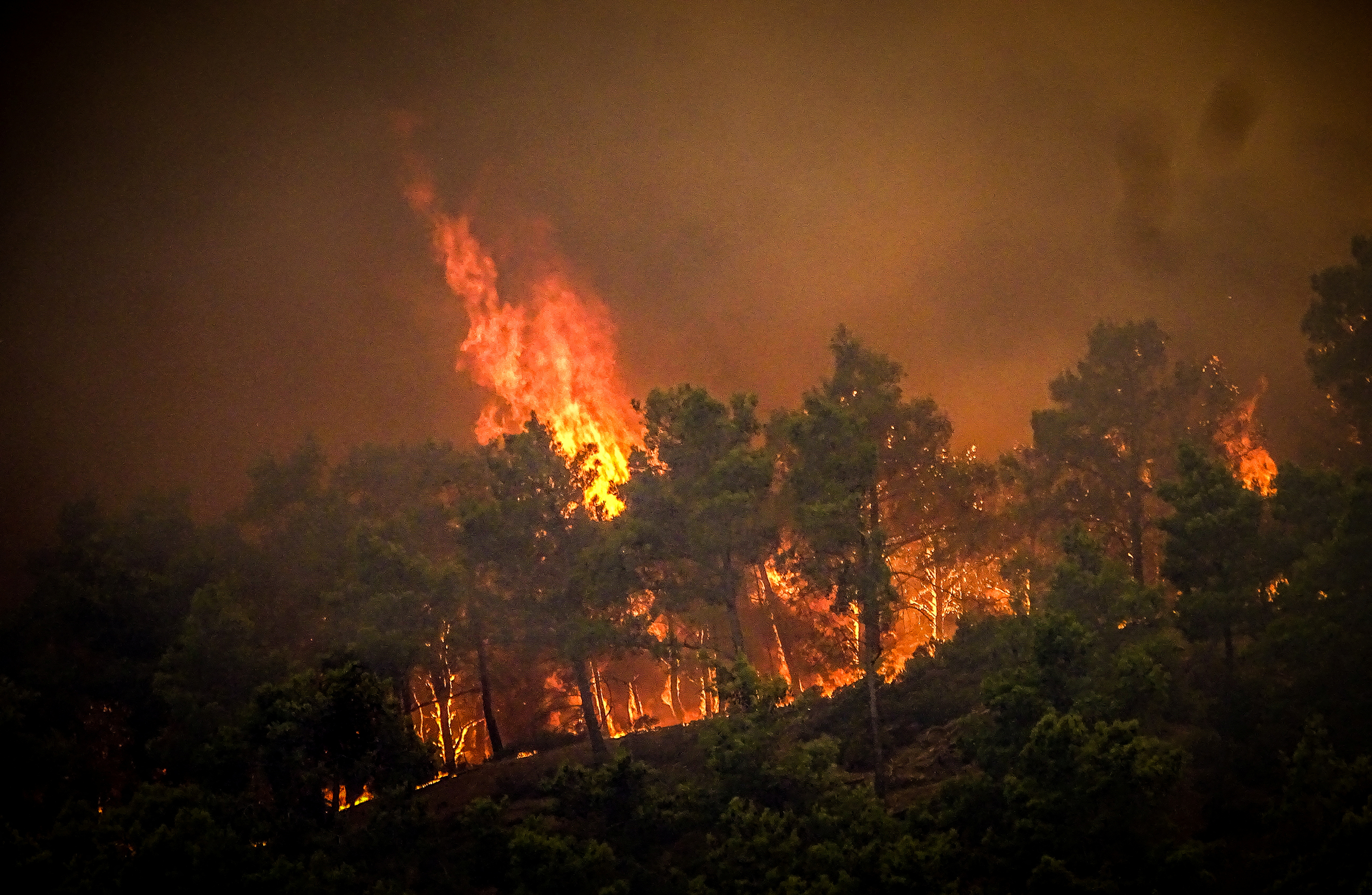 Smoke rises from a wildfire on the island of Rhodes