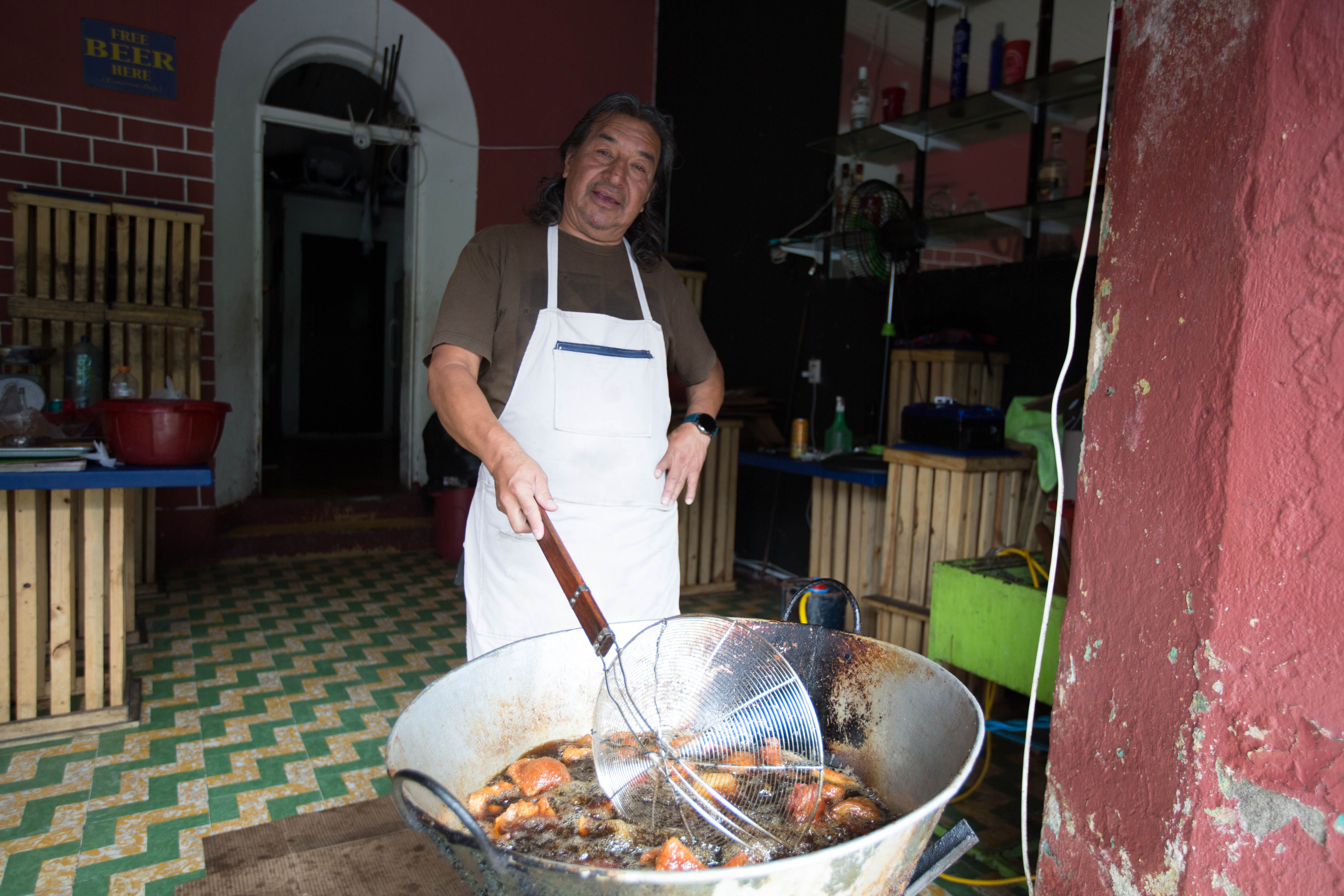 Edgar Ixquiak, a 62-year-old businessman, prepares pork rinds in his shop near Guatemala City’s historic centre