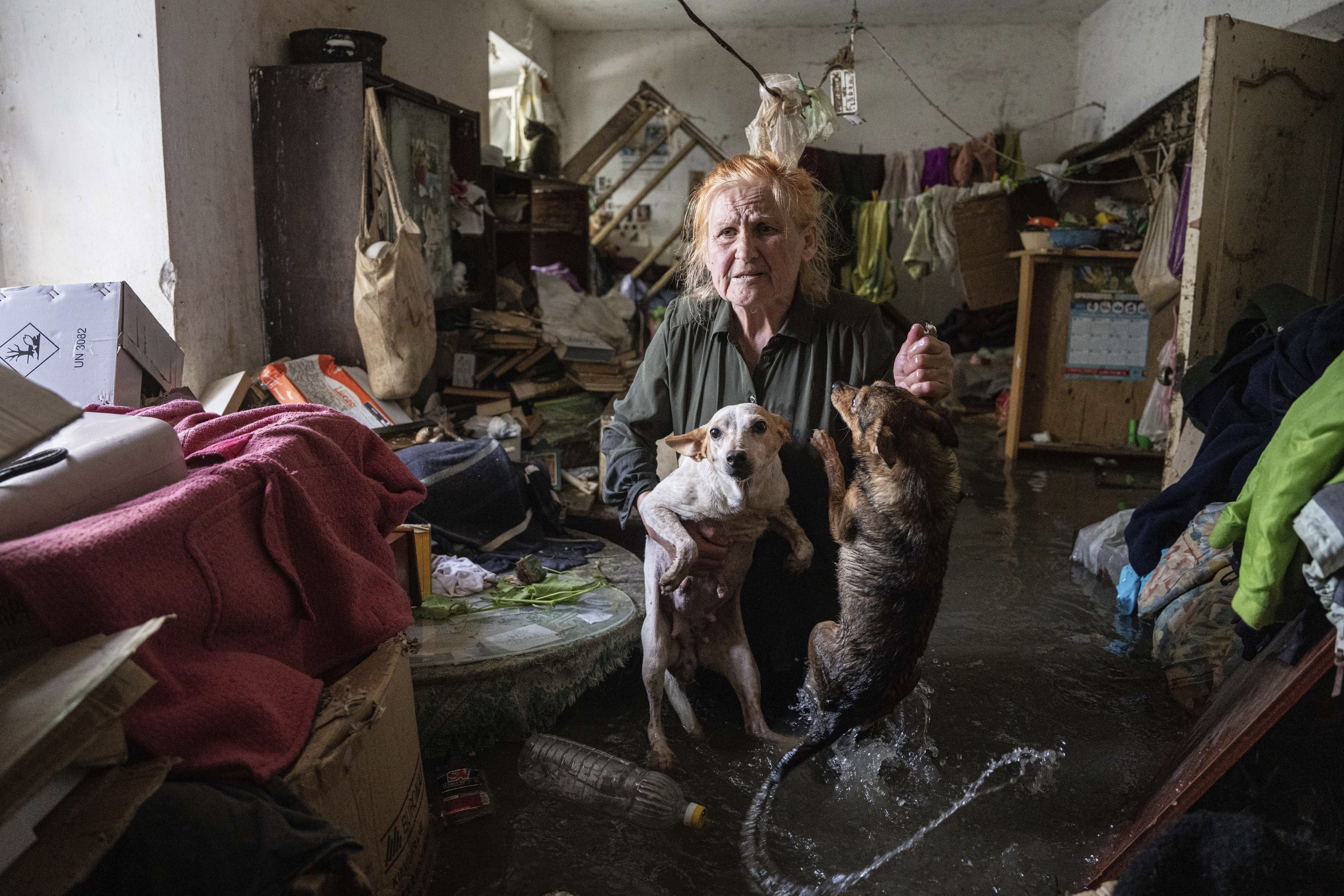 Local resident Tetiana holds her pets,