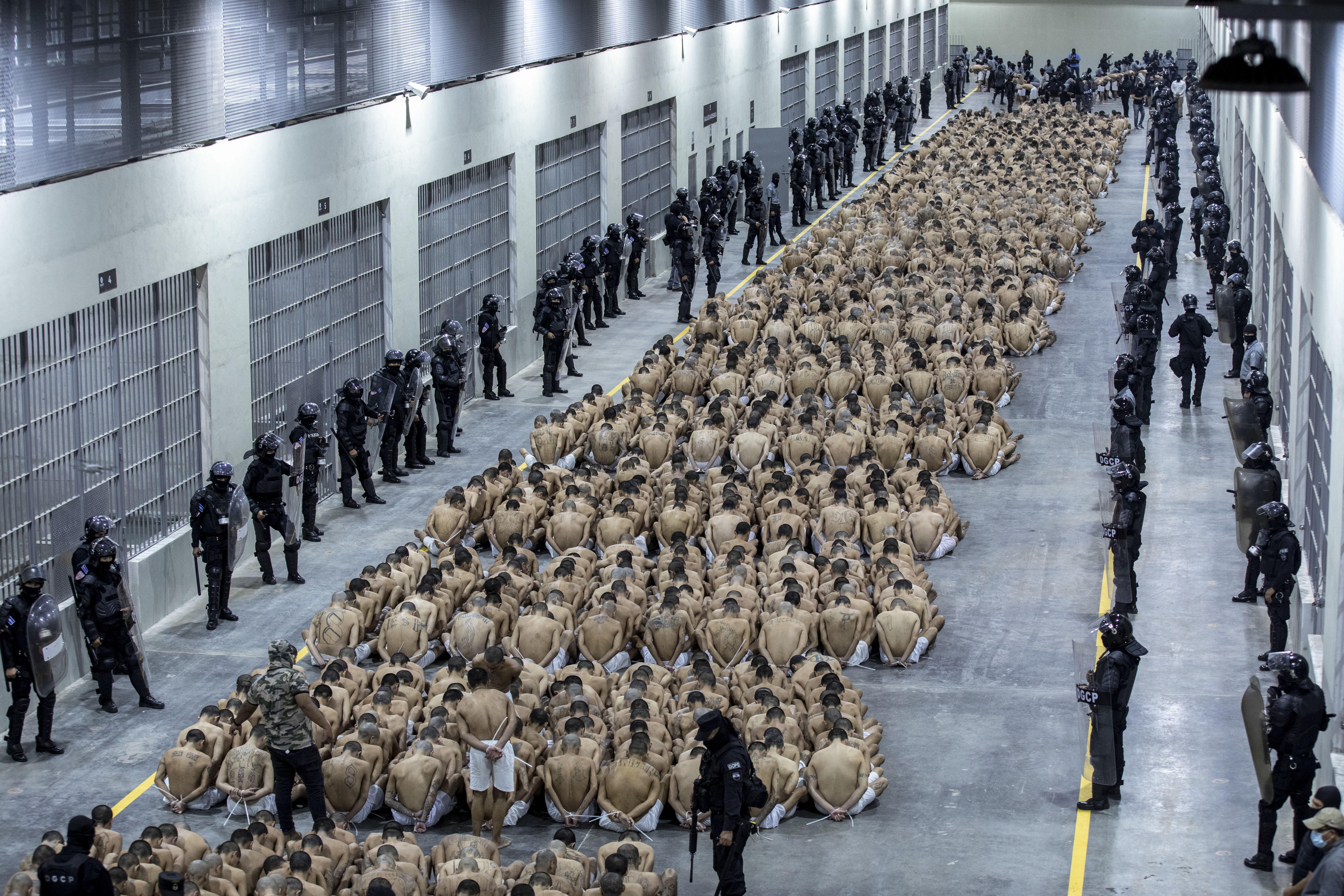 Incarcerated people are watched over by guards in a prison in Tecoluca, El Salvador, on March 15, 2023