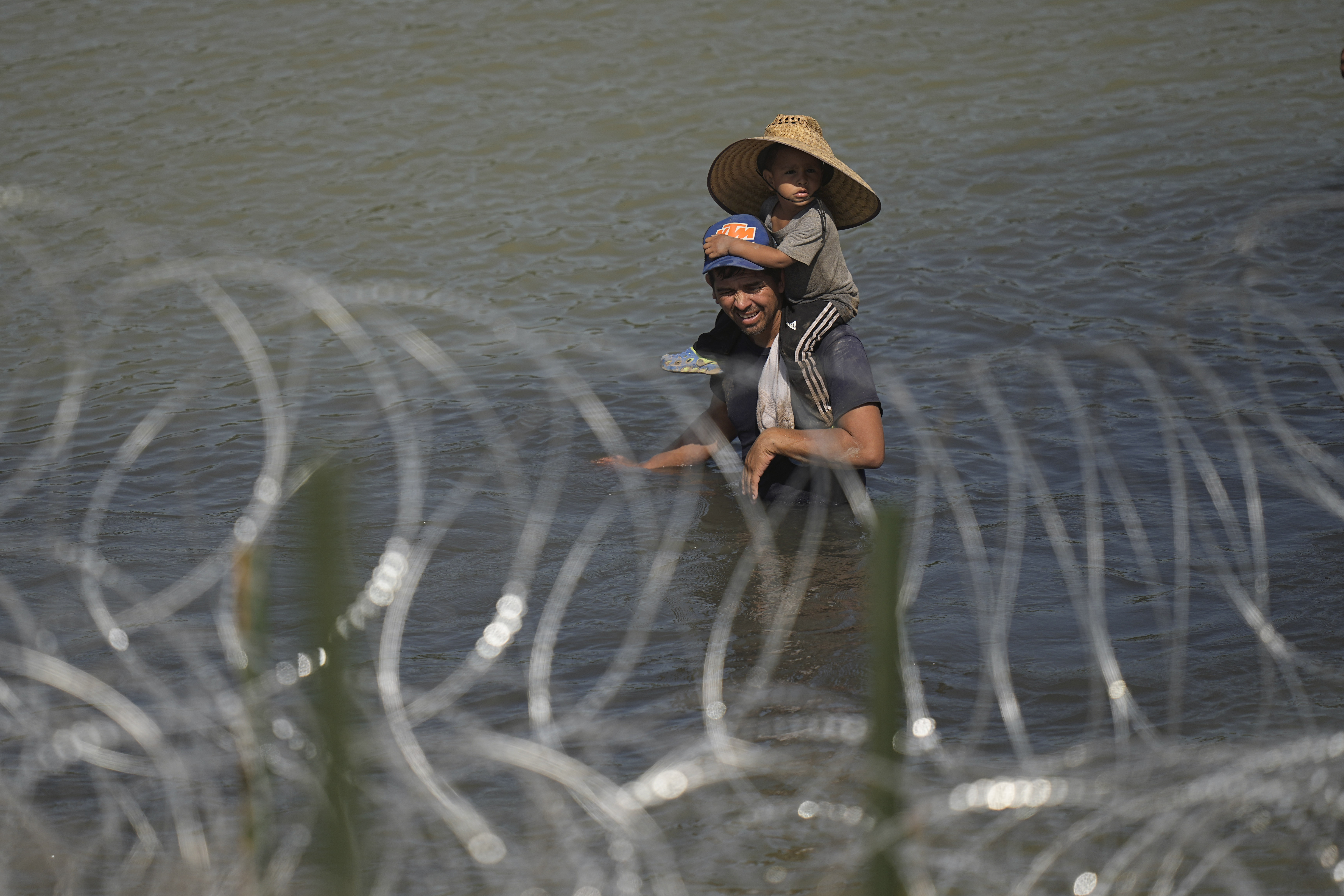 A man carries a child at US Mexico border
