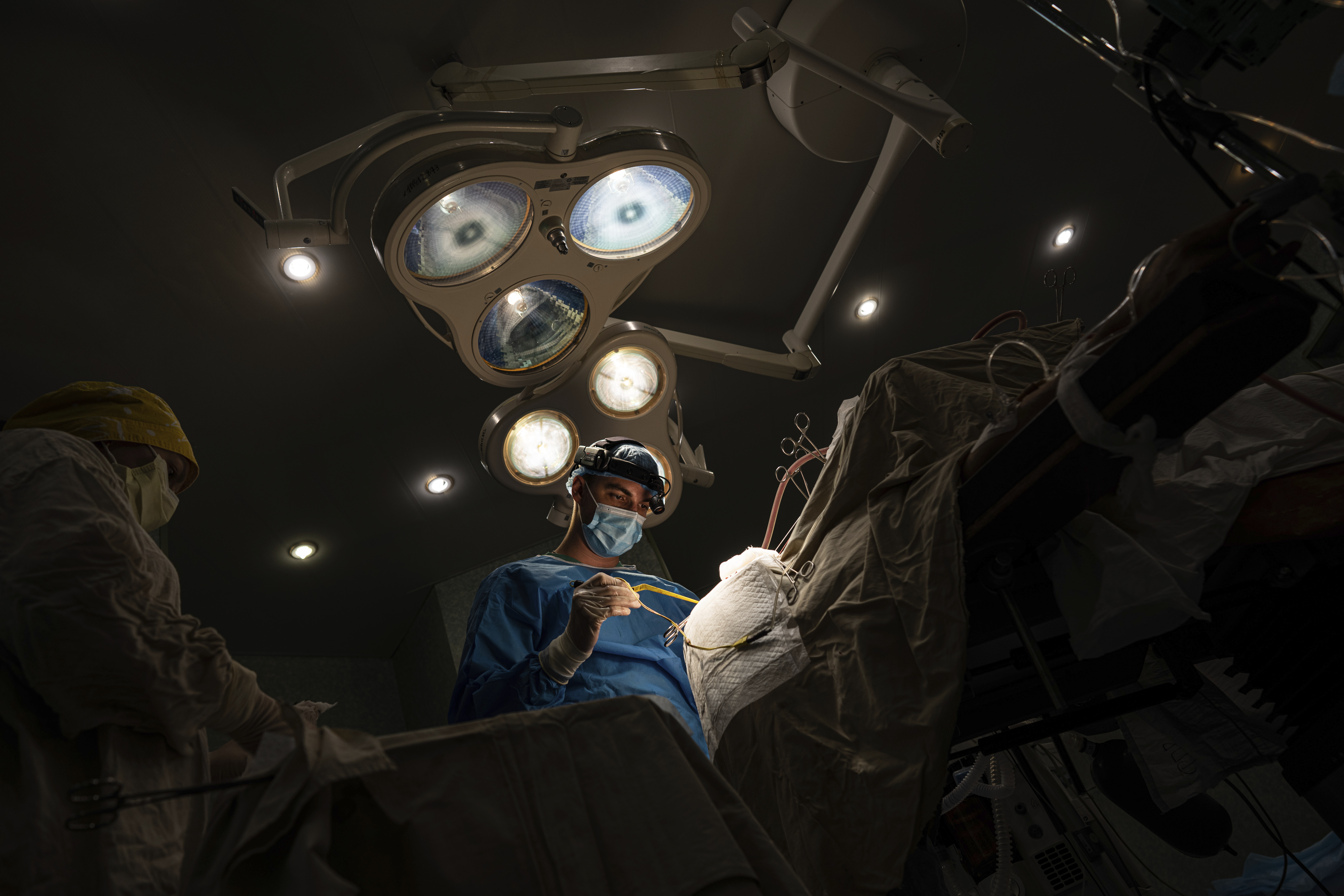 Neurosurgeon Nikita Lombrozo operates on a patient who sustained a shrapnel injury