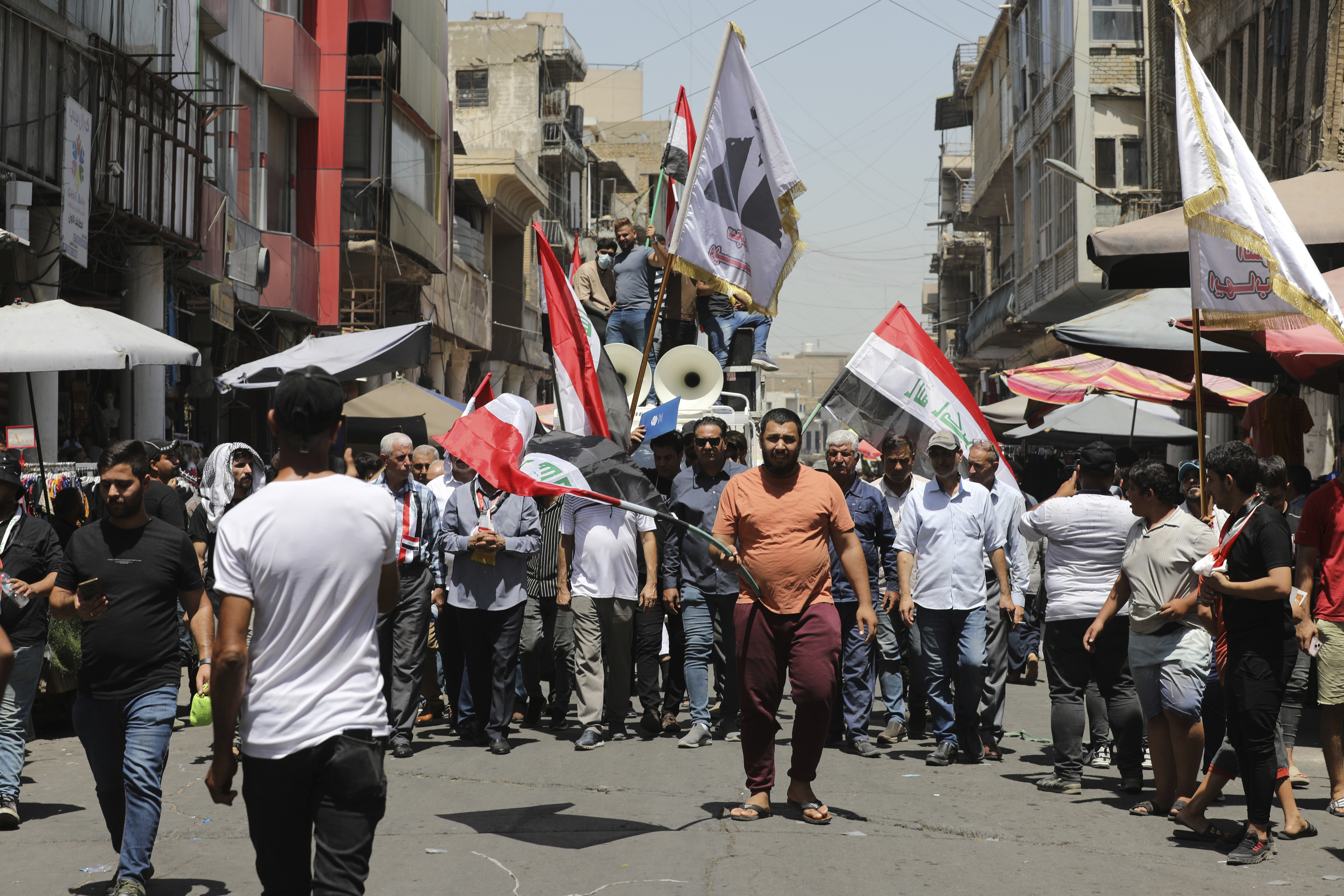 Demonstrators protest in front of the Iraqi central bank as currency plummets against the U.S. dollar, in Baghdad, Iraq, Wednesday, July. 26, 2023. Over the past two days, the market rate of the dollar jumped from 1,470 dinar per dollar to 1,570 dinar per dollar.