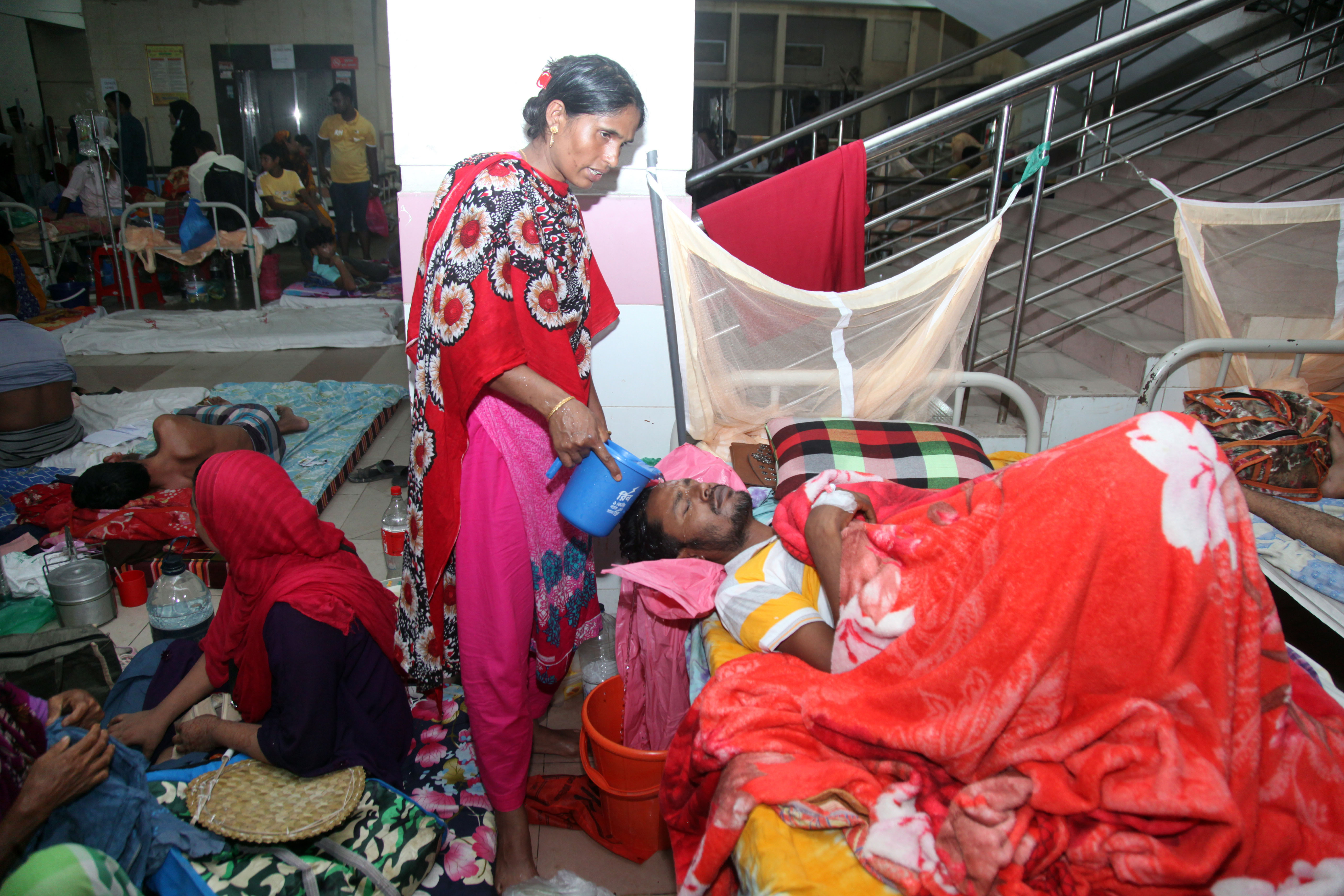 People being treated at a crowded hospital in Dhaka