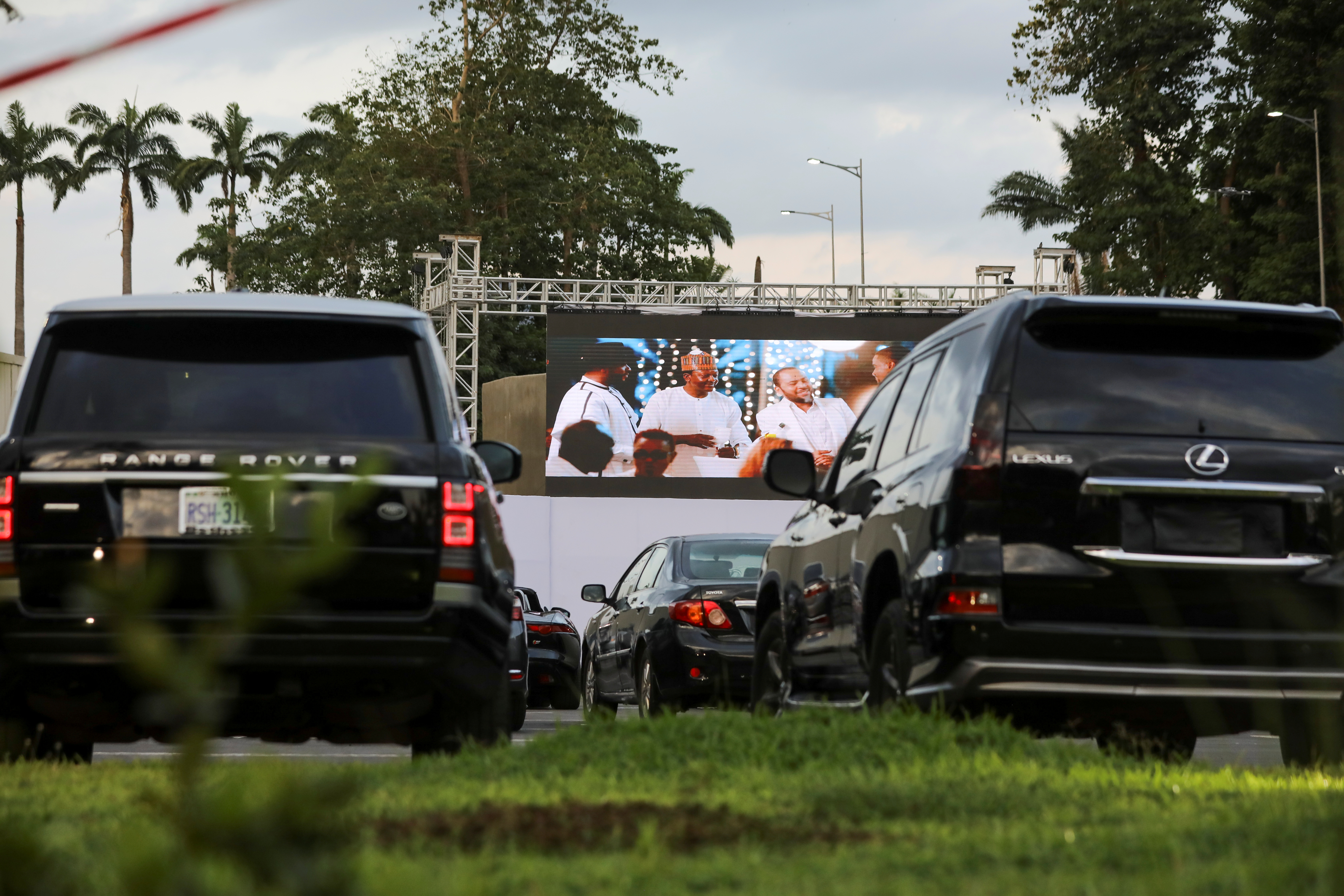 Movie audiences sit in their parked cars as they watch a movie at a drive-in cinema amid the COVID-19 outbreak in Abuja