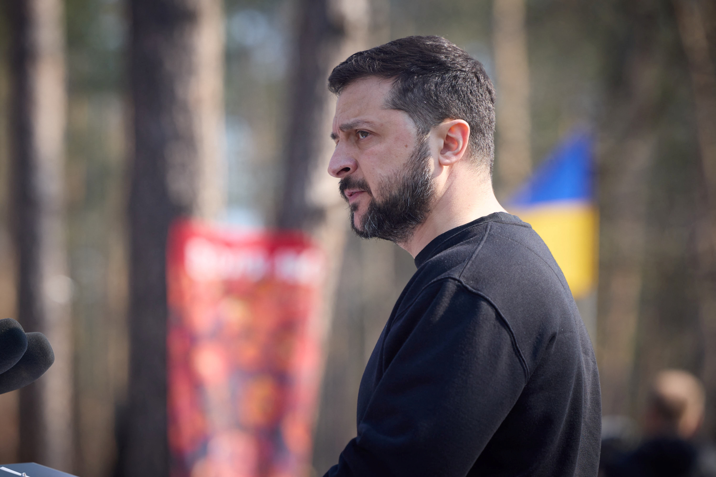 Ukraine's President Volodymyr Zelenskyi sings a national anthem during a commemorative ceremony for Ukrainian servicemen