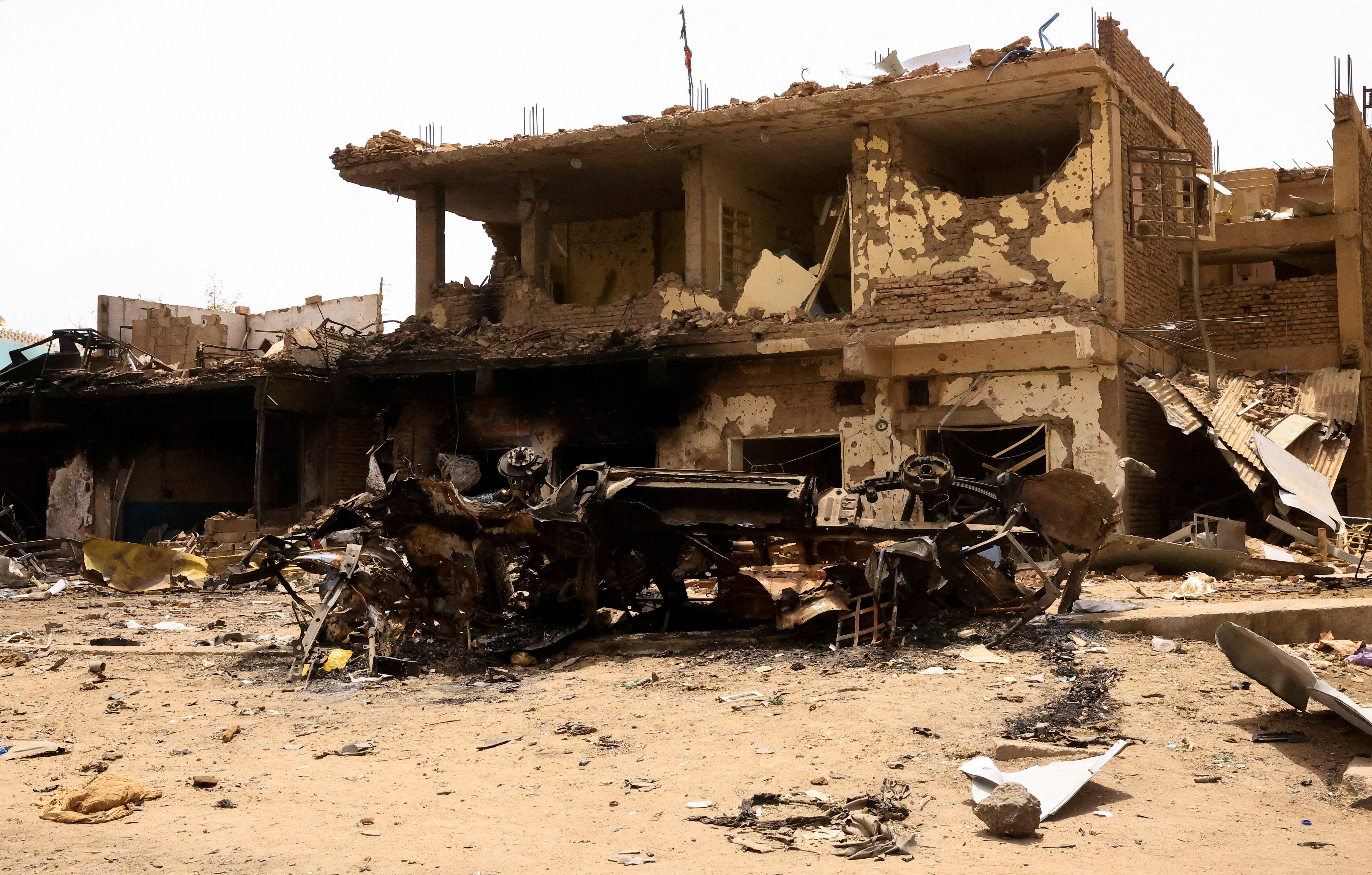 FILE PHOTO: A damaged car and buildings are seen at the central market during clashes between the paramilitary Rapid Support Forces and the army in Khartoum North, Sudan. April 27, 2023. REUTERS/ Mohamed Nureldin Abdallah/File Photo