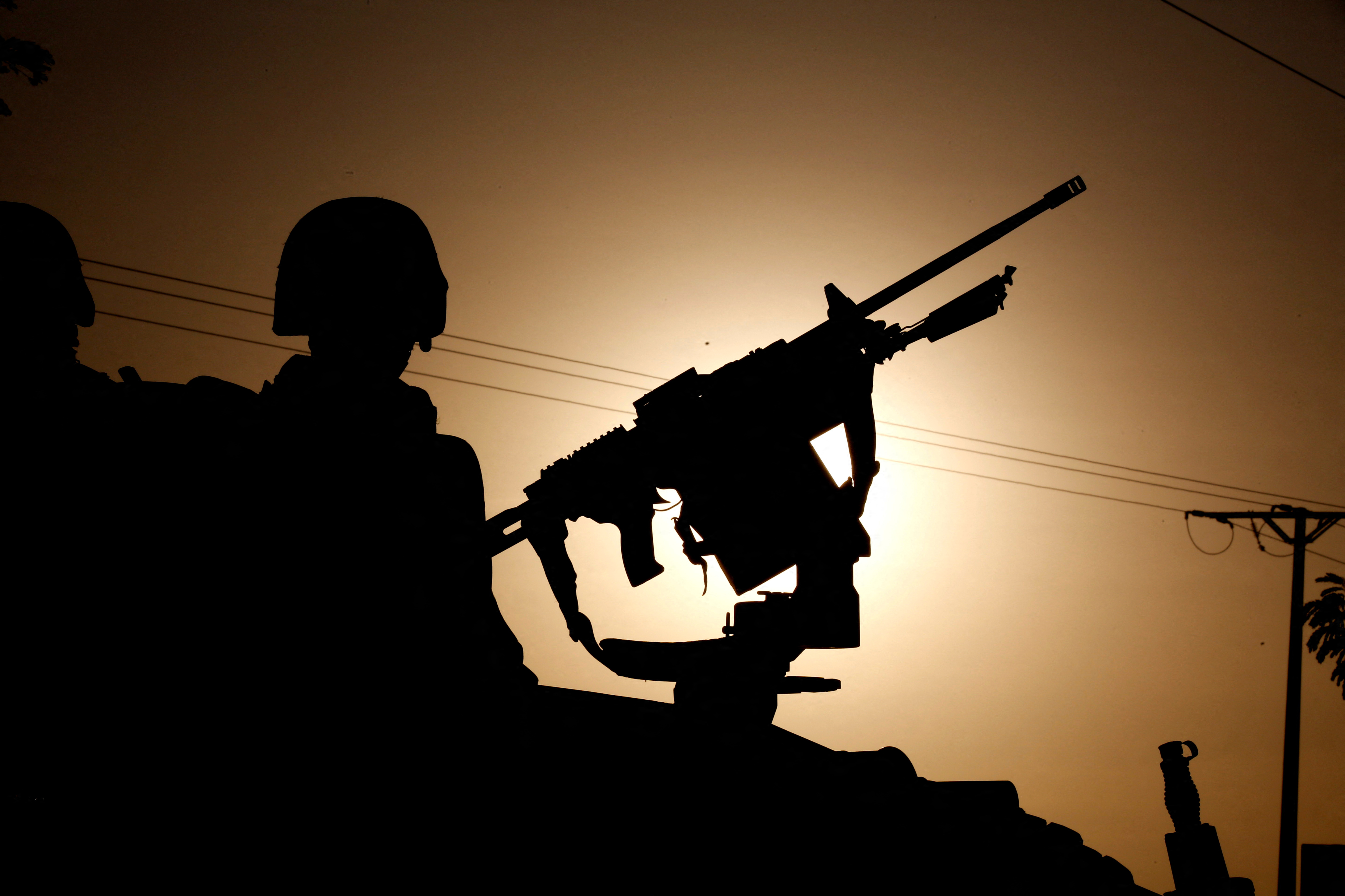 Silhouettes of members of the regional ECOWAS force are seen