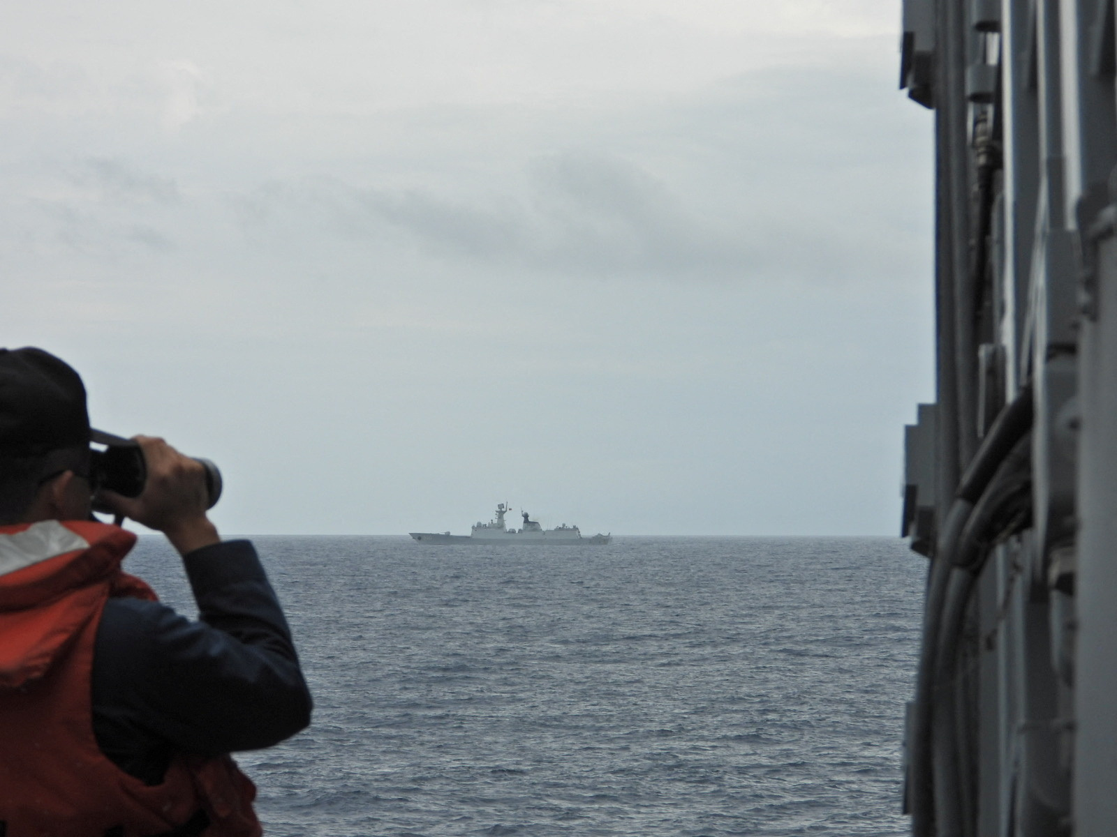 A sailor monitors China's People's Liberation Army (PLA) Navy frigate Xuzhou from Taiwan's guided missile frigate Tian Dan at an undisclosed location, in this handout image provided by Taiwan Navy August 20, 2023.