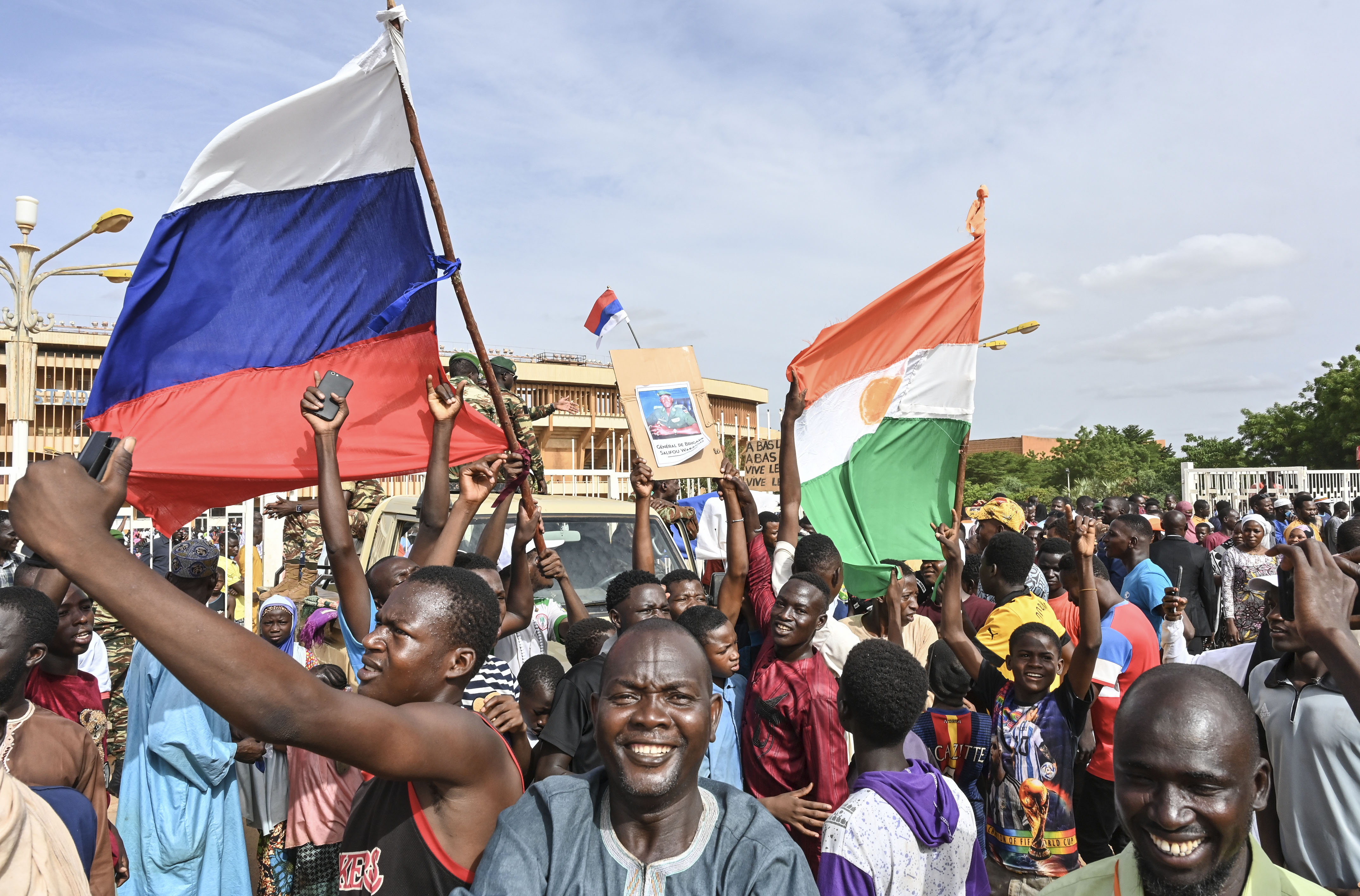 Thousands of supporters of the military coup in Niger gathered at a Niamey stadium Sunday, when a deadline set by the West African regional bloc ECOWAS to return the deposed President Mohamed Bazoum to power is set to expire, according to AFP journalists. A delegation of members of the ruling National Council for the Safeguard of the Homeland (CNSP) arrived at the 30,000-seat stadium to cheers from supporters, many of whom were drapped in Russian flags and portraits of CNSP leaders. (Photo by - / AFP)