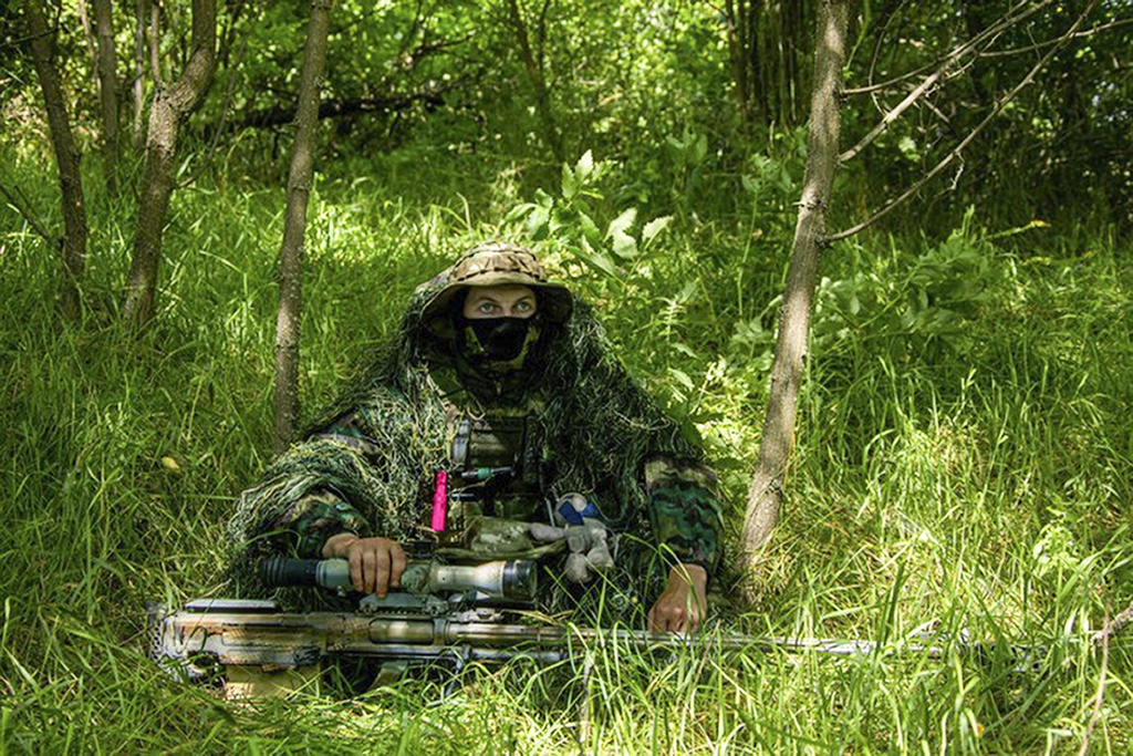 In this photo released by the Russian Defense Ministry Press Service on Thursday, Aug. 10, 2023, a Russian sniper sits at his position toward Ukrainian positions at the Zapad (West) group of Russian troops at an undisclosed location of Ukraine. (Russian Defense Ministry Press Service via AP)