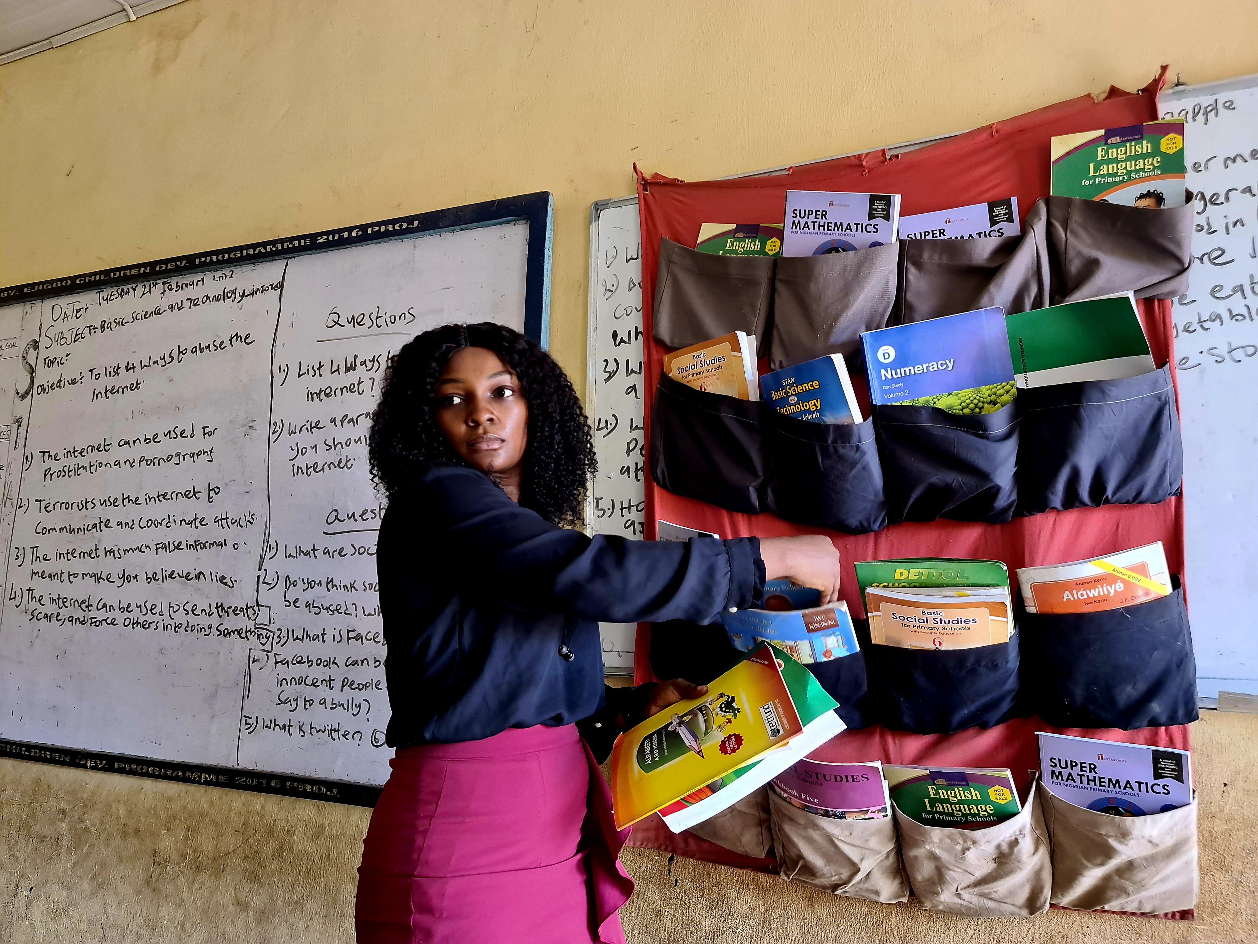 One of the coordinators of The Hanging Library initiative visits a school in Lagos after the installation of a library