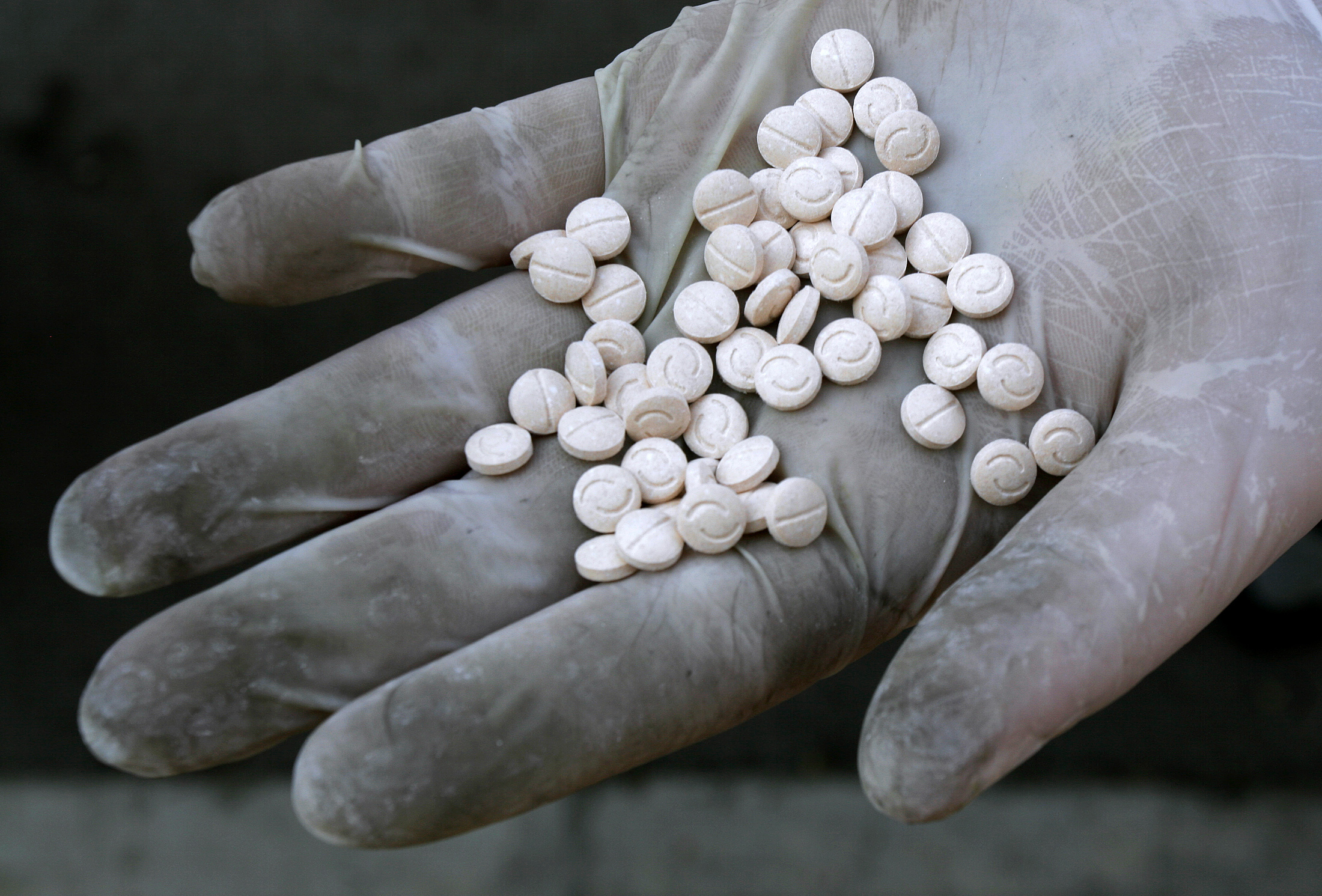 Captagon pills on an outstretched hand