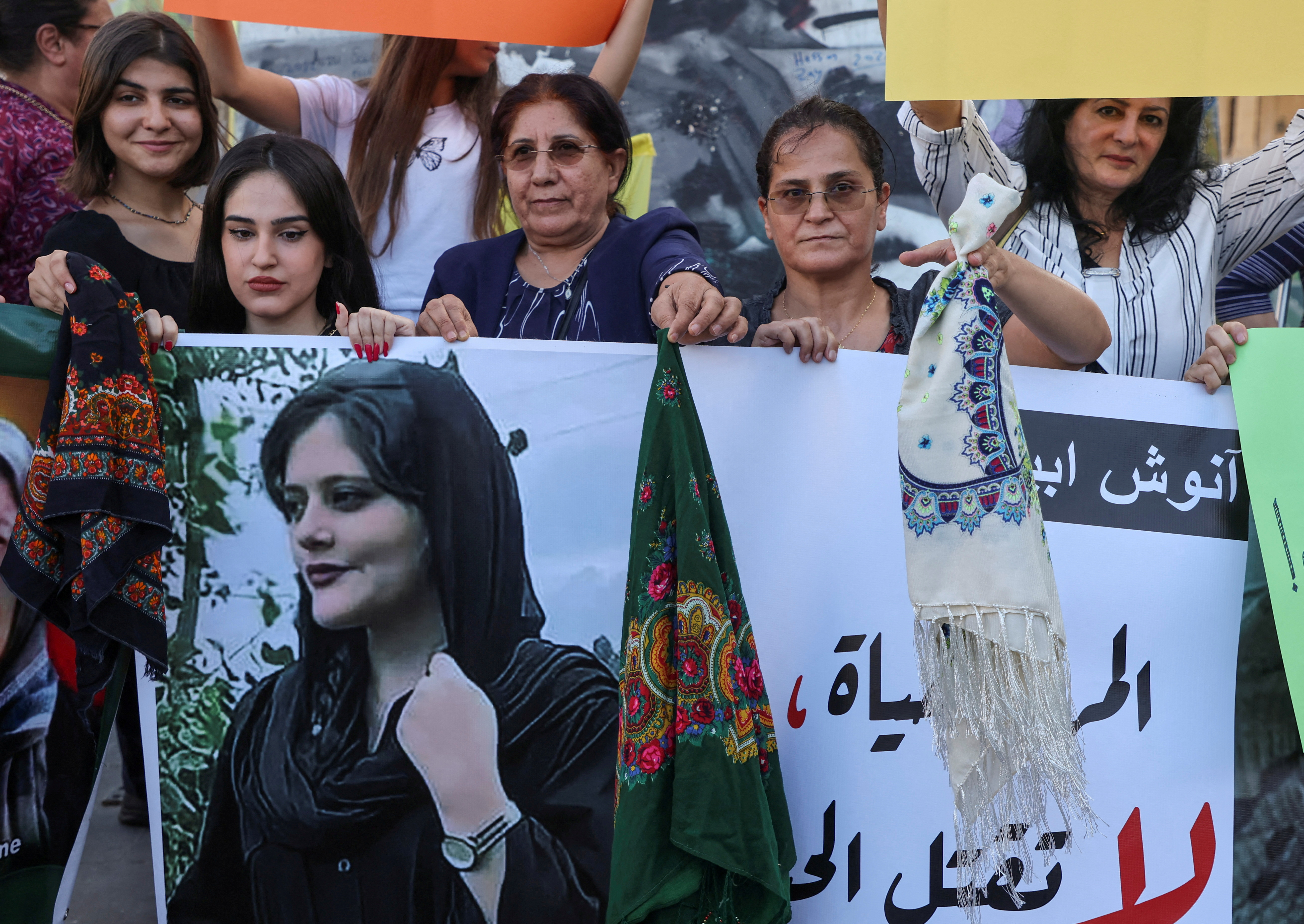 Women hold a picture of Mahsa Amini during a sit-in following her death, at Martyrs' Square in Beirut, Lebanon September 21, 2022