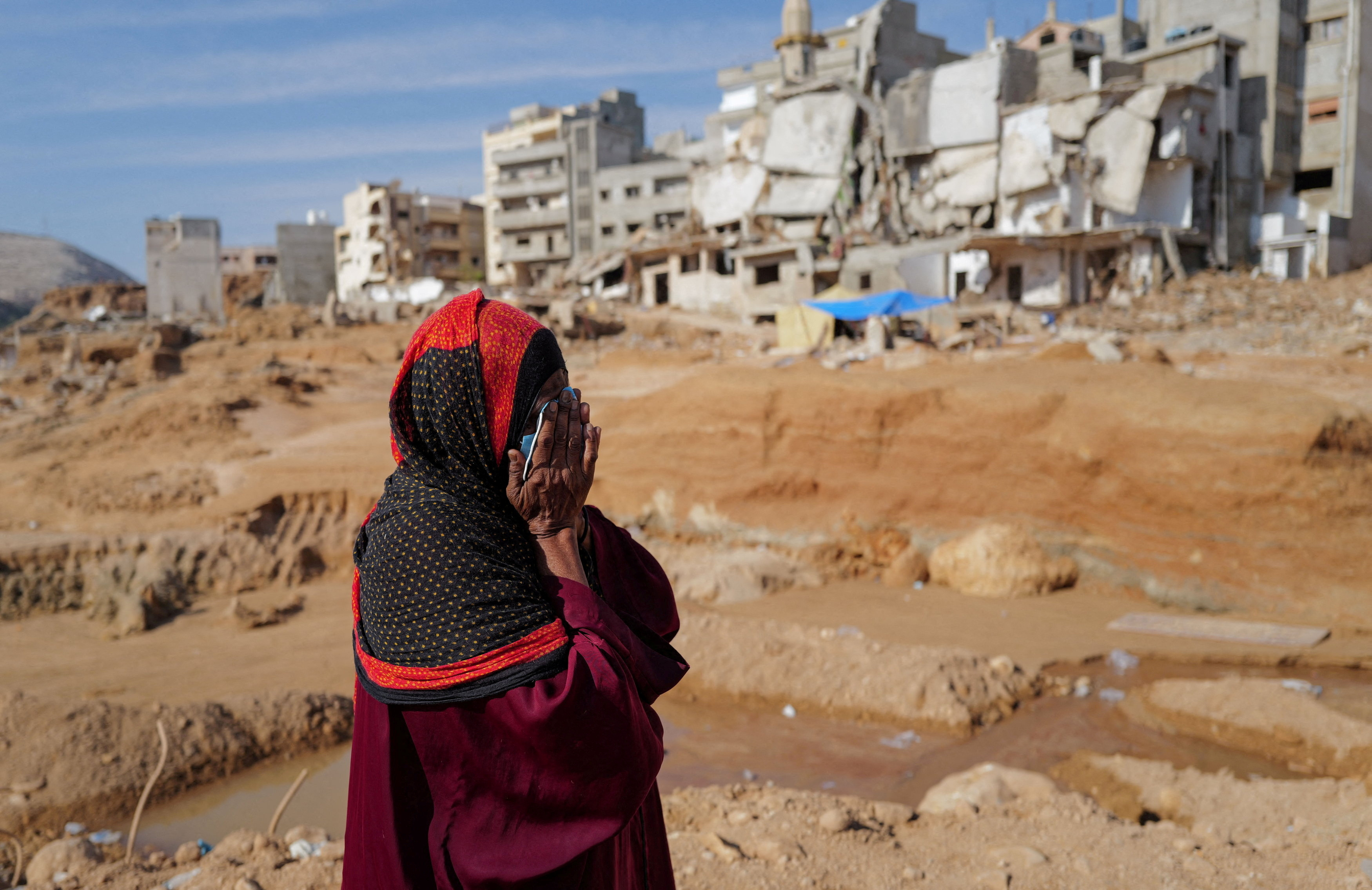 Aisha, 51, who said she lost five family members when the deadly storm hit her city, reacts as she walks past destroyed houses, in Derna, Libya September 17, 2023. REUTERS/Zohra Bensemra TPX IMAGES OF THE DAY