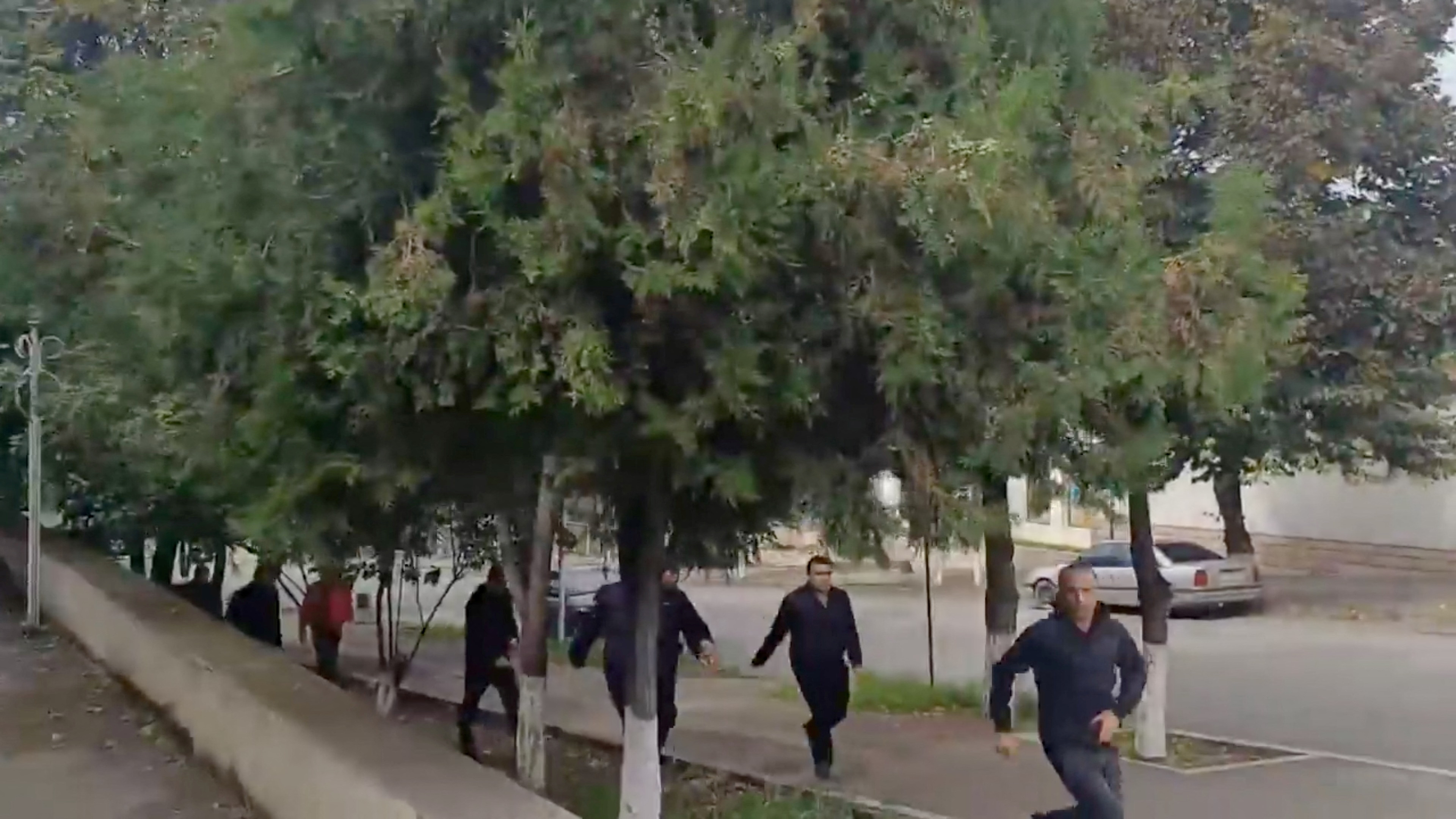 People run as gunfire and explosions are heard in Stepanakert, called Khankendi by Azerbaijan, in the Nagorno-Karabakh region, September 19, 2023, in this screengrab obtained from a handout video. Artsakh Public TV/Handout via REUTERS THIS IMAGE HAS BEEN SUPPLIED BY A THIRD PARTY. NO RESALES. NO ARCHIVES. ARMENIA OUT. NO COMMERCIAL OR EDITORIAL SALES IN ARMENIA. AZERBAIJAN OUT. NO COMMERCIAL OR EDITORIAL SALES IN AZERBAIJAN