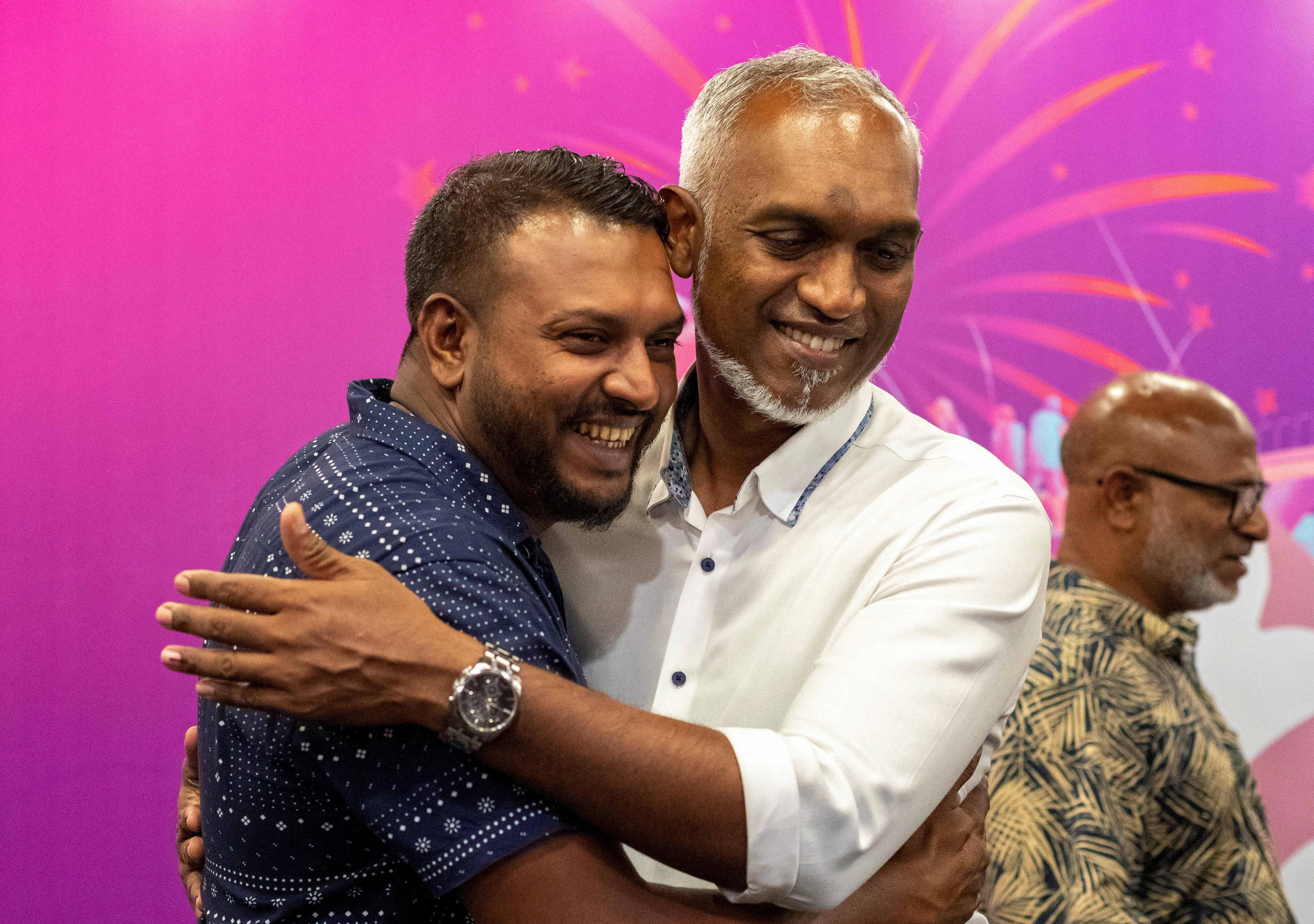 A supporter hugs Mohamed Muizzu