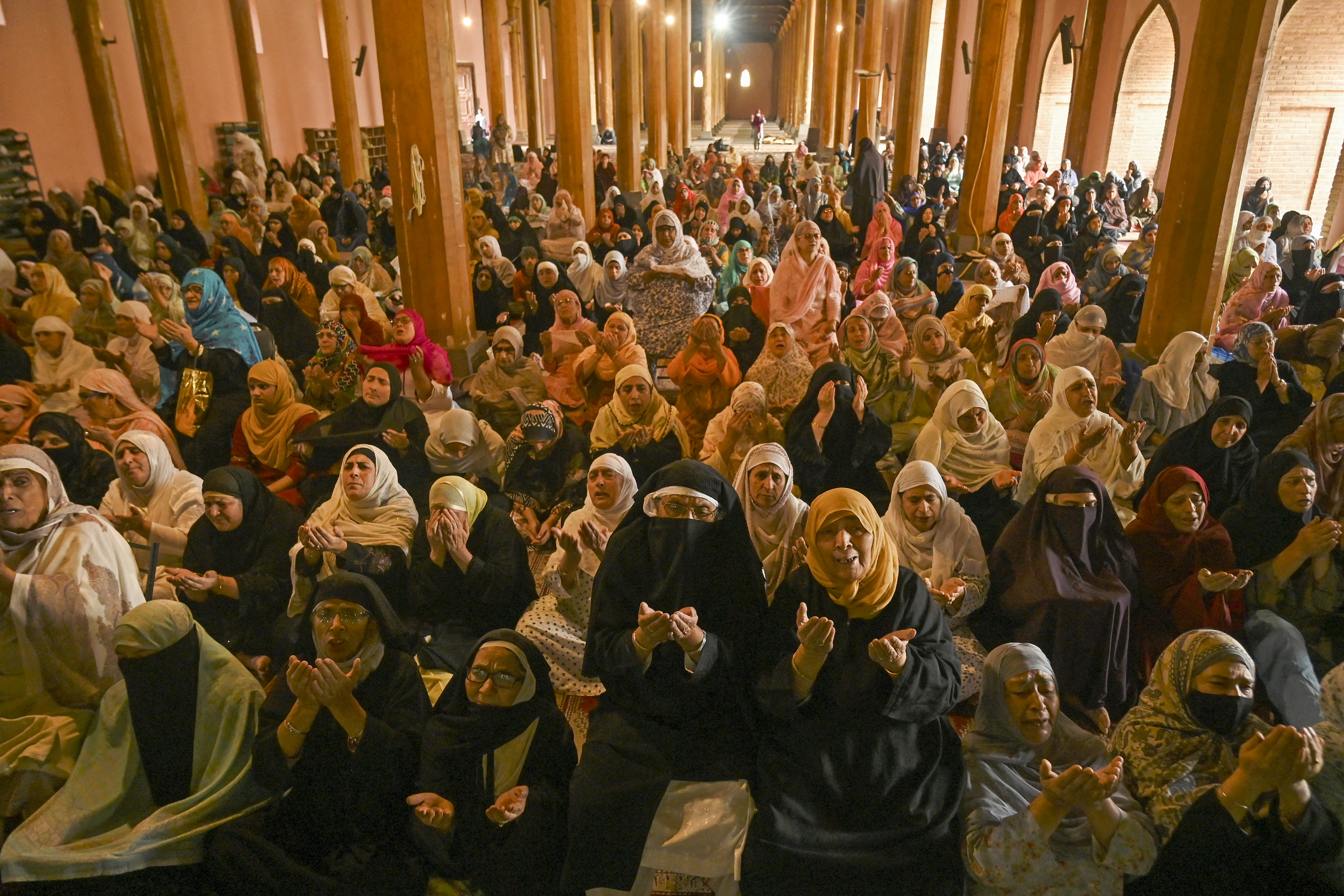 Kashmiri women pray as Mirwaiz delivers the Friday sermon at Jamia Masjid