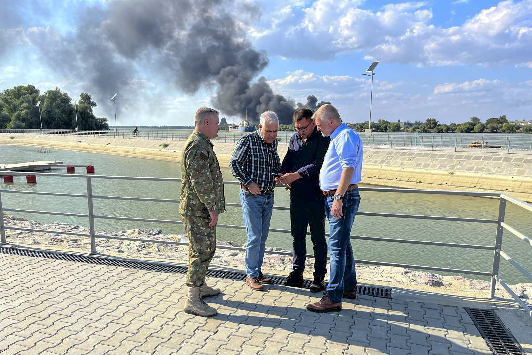 In this image released by the Romanian Defense Ministry, Defense Minister Angel Tilvar, second from left, visits areas in the Danube Delta close to the Ukrainian border, Wednesday, Sept. 6, 2023. Romania's defense minister said Wednesday that pieces apparently of a drone from Russia's recent attacks on Ukraine's port on the Danube River have been found on the territory of his country. Romania is a NATO member. (Romanian Defense Ministry via AP)