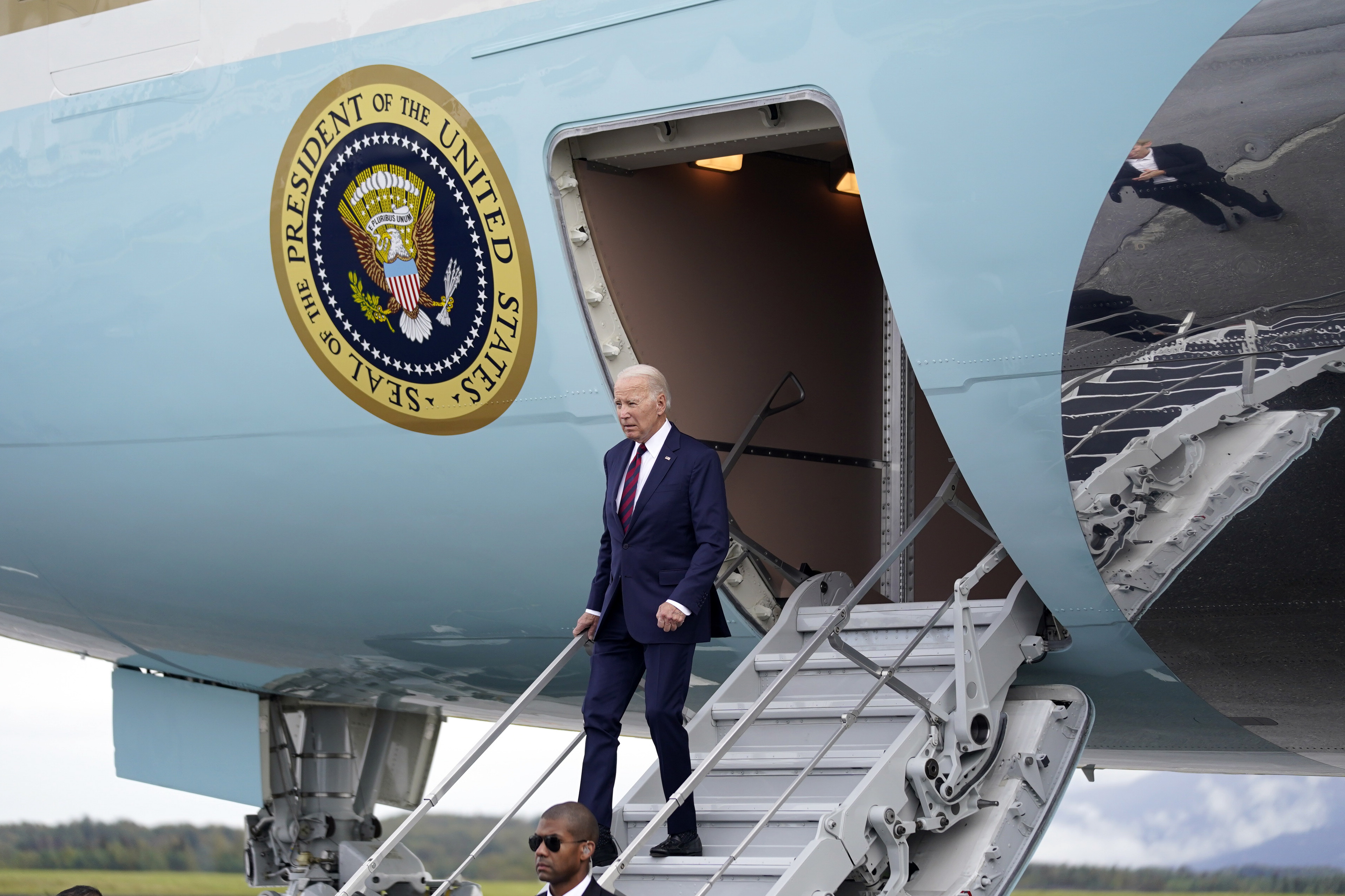 President Joe Biden descends Air Force One as he arrives in Anchorage, Alaska