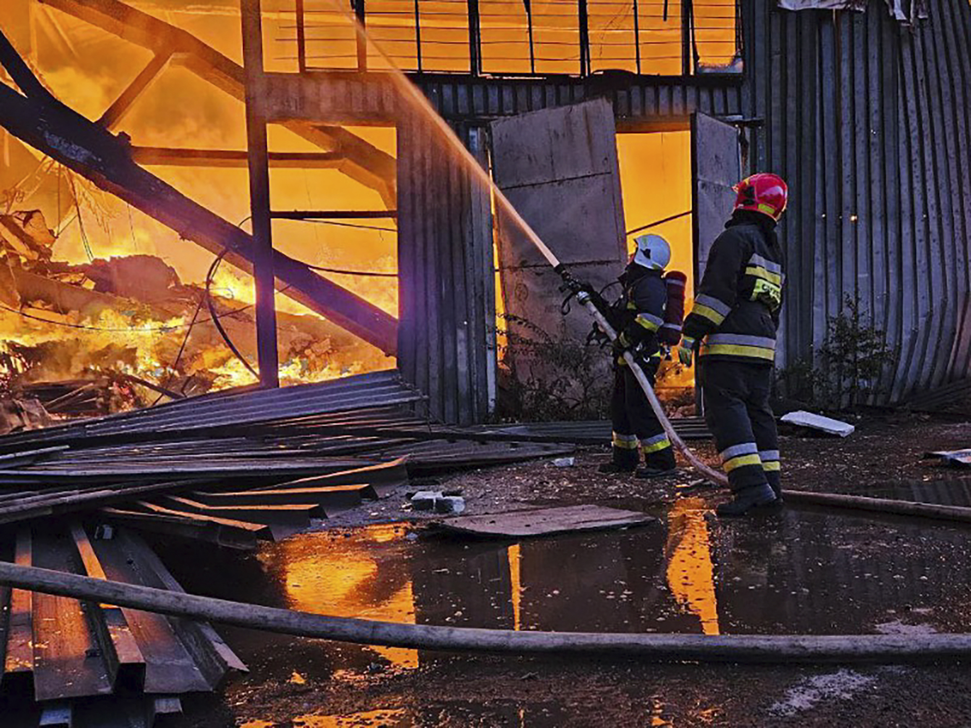 Firefighters at the scene of a blaze caused by a Russian attack on the city of Lviv