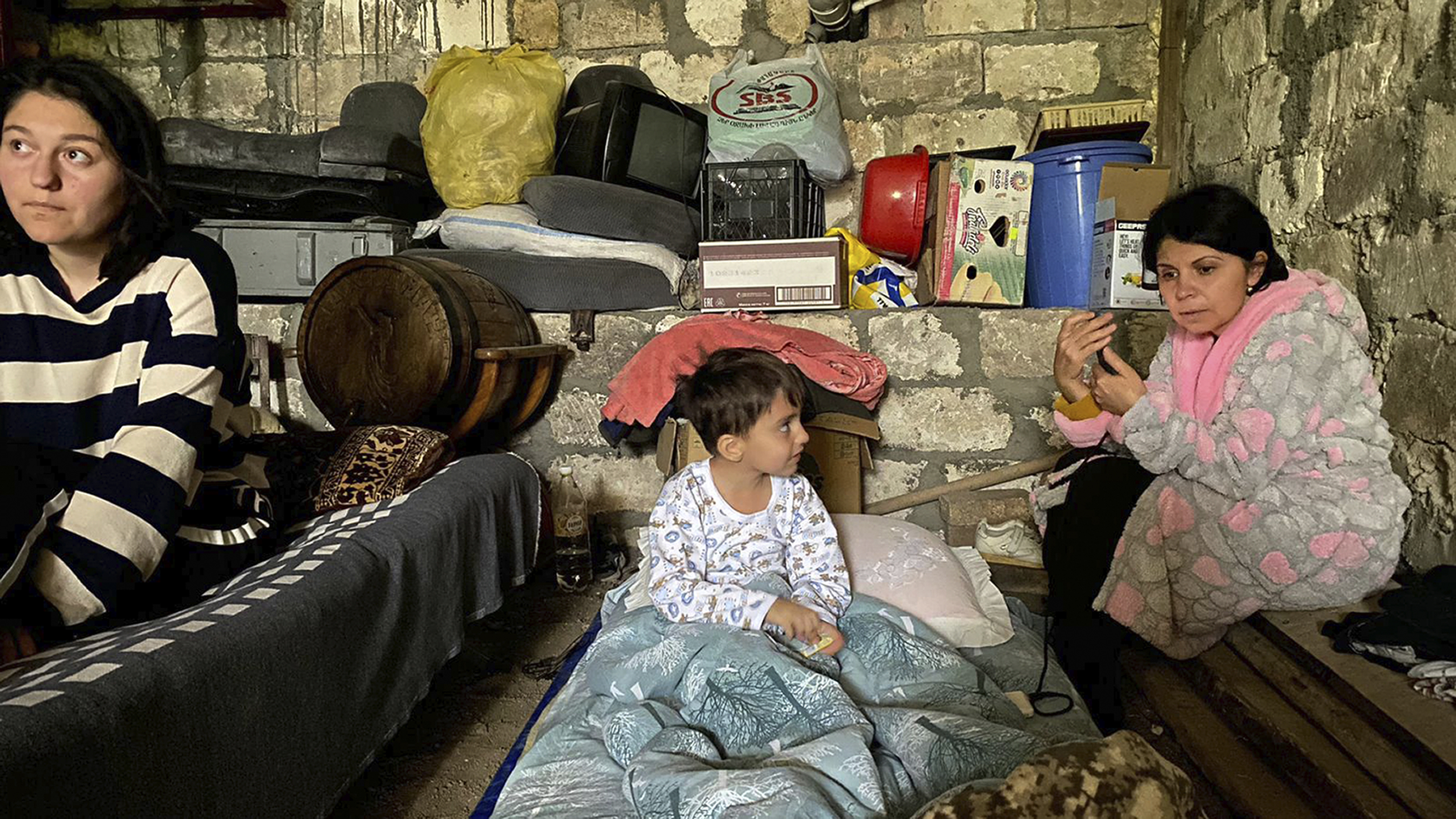 Children are in a shelter during shelling in Stepanakert in Nagorno-Karabakh, Azerbaijan Wednesday, Sept. 20, 2023. Azerbaijan's forces fired artillery at Armenian positions in the region of Nagorno-Karabakh. Ethnic Armenian officials reported heavy shelling around the regional capital of Stepanakert. (AP Photo/Siranush Sargsyan)