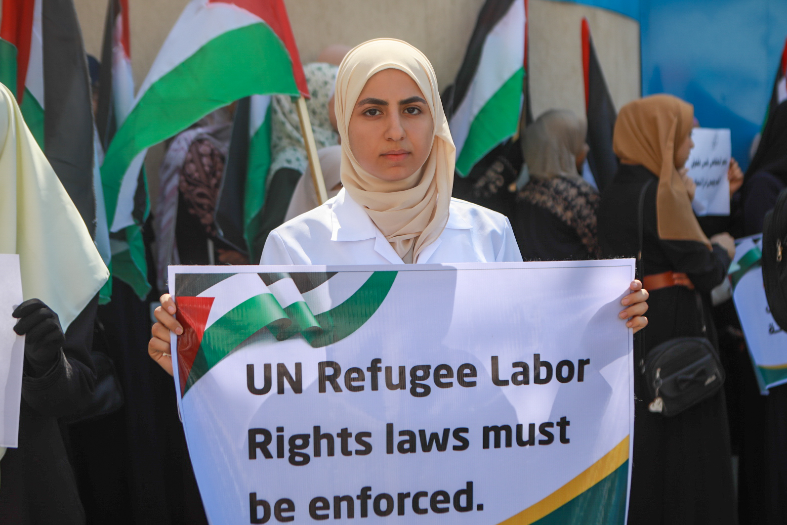 A girl holds a banner