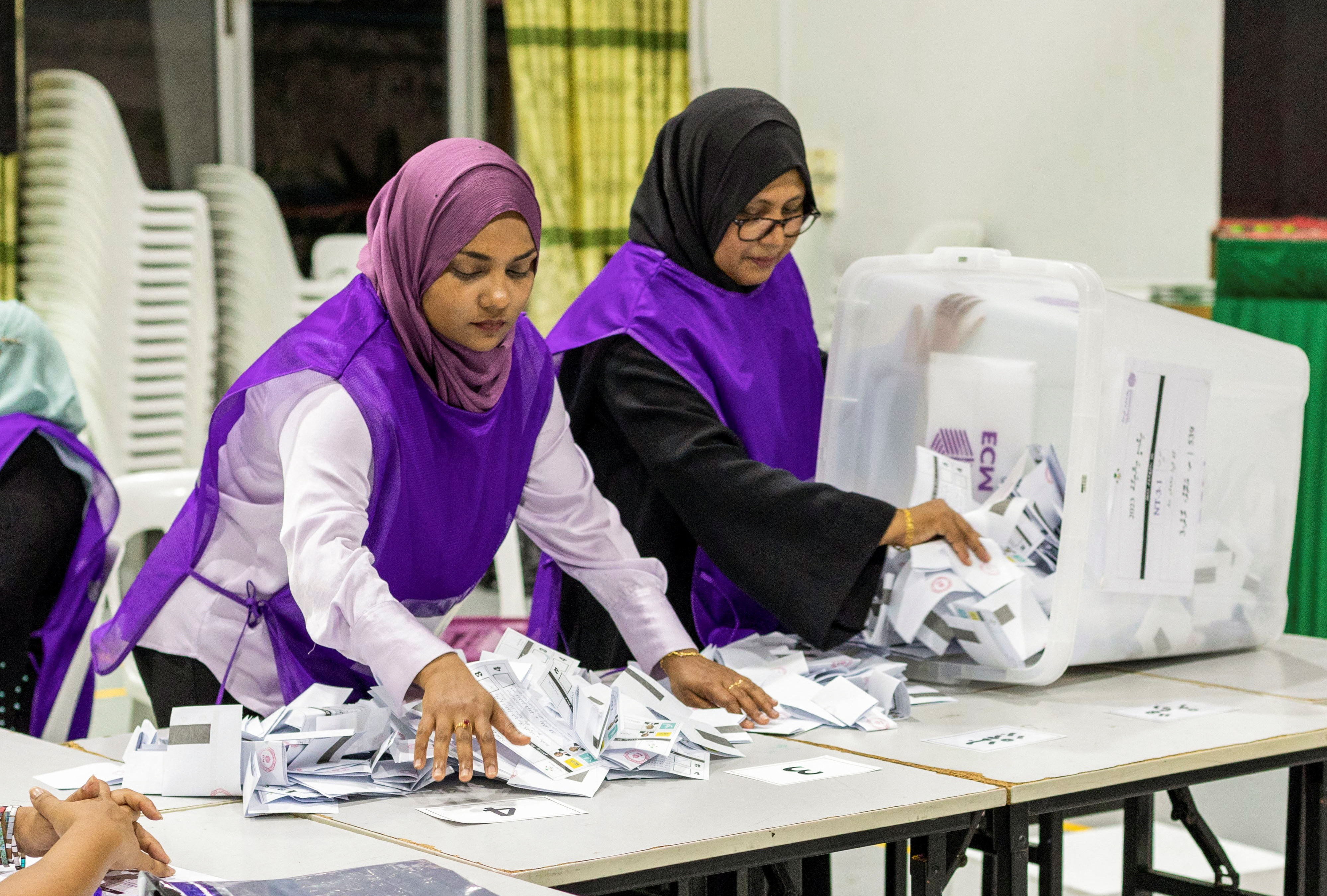 Members of Elections Commission empty a ballot box to count the ballots during the second round of a presidential election in Male