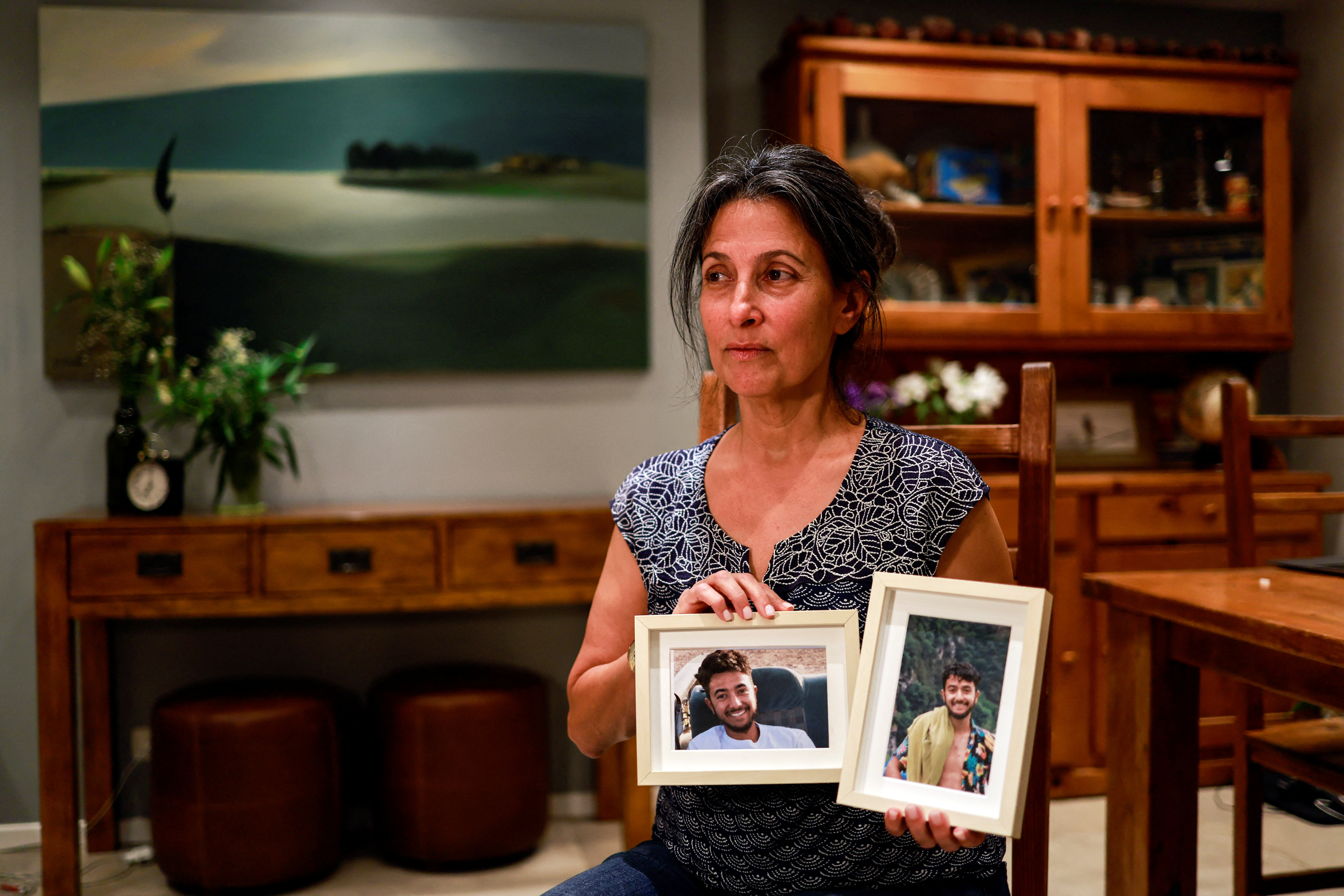 Rachel Goldberg, Hersh Goldberg-Polin’s mother, holds photos of her son at their home in Jerusalem