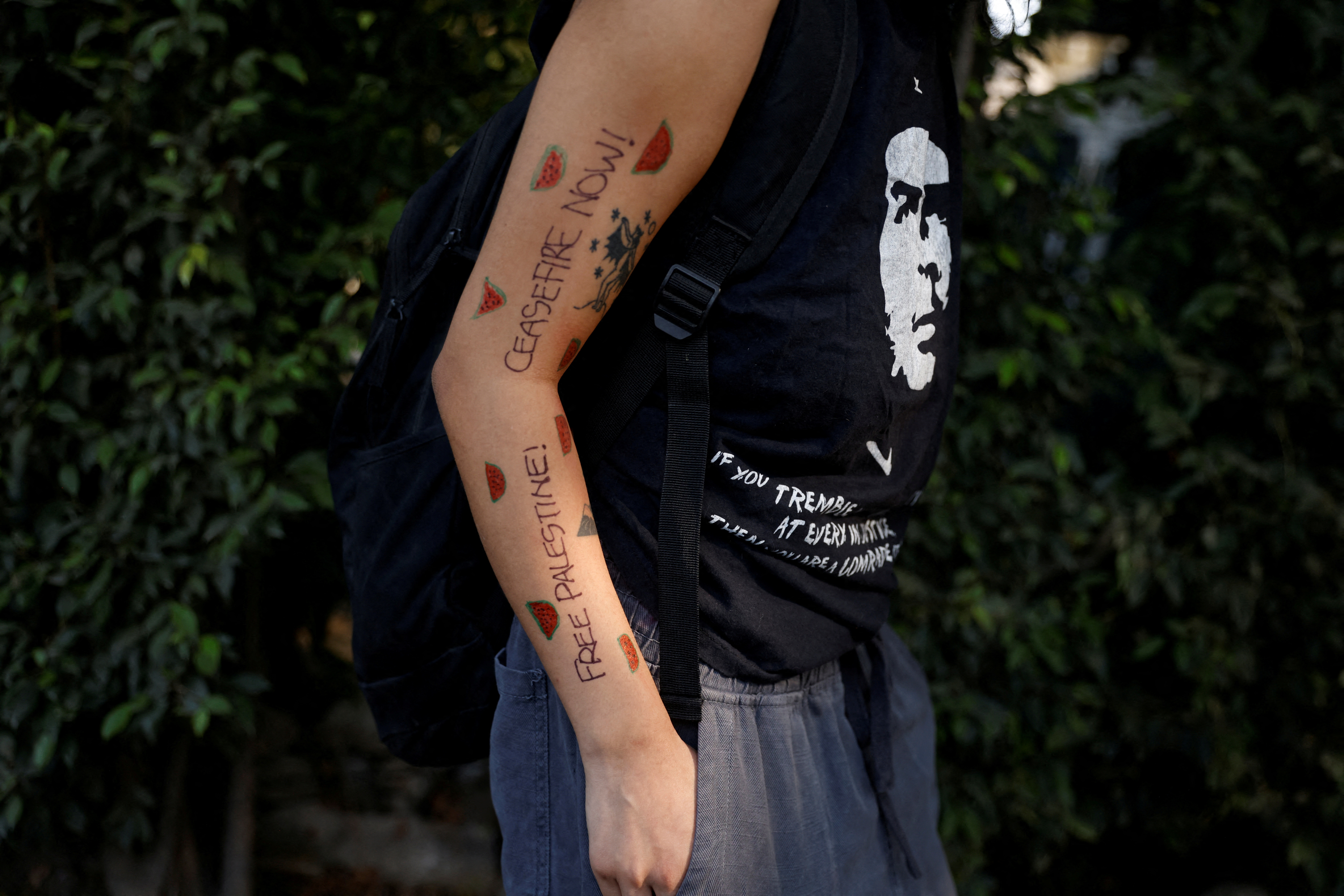 Messages written on the hand of a protester near Embassy of Israel in New Delhi