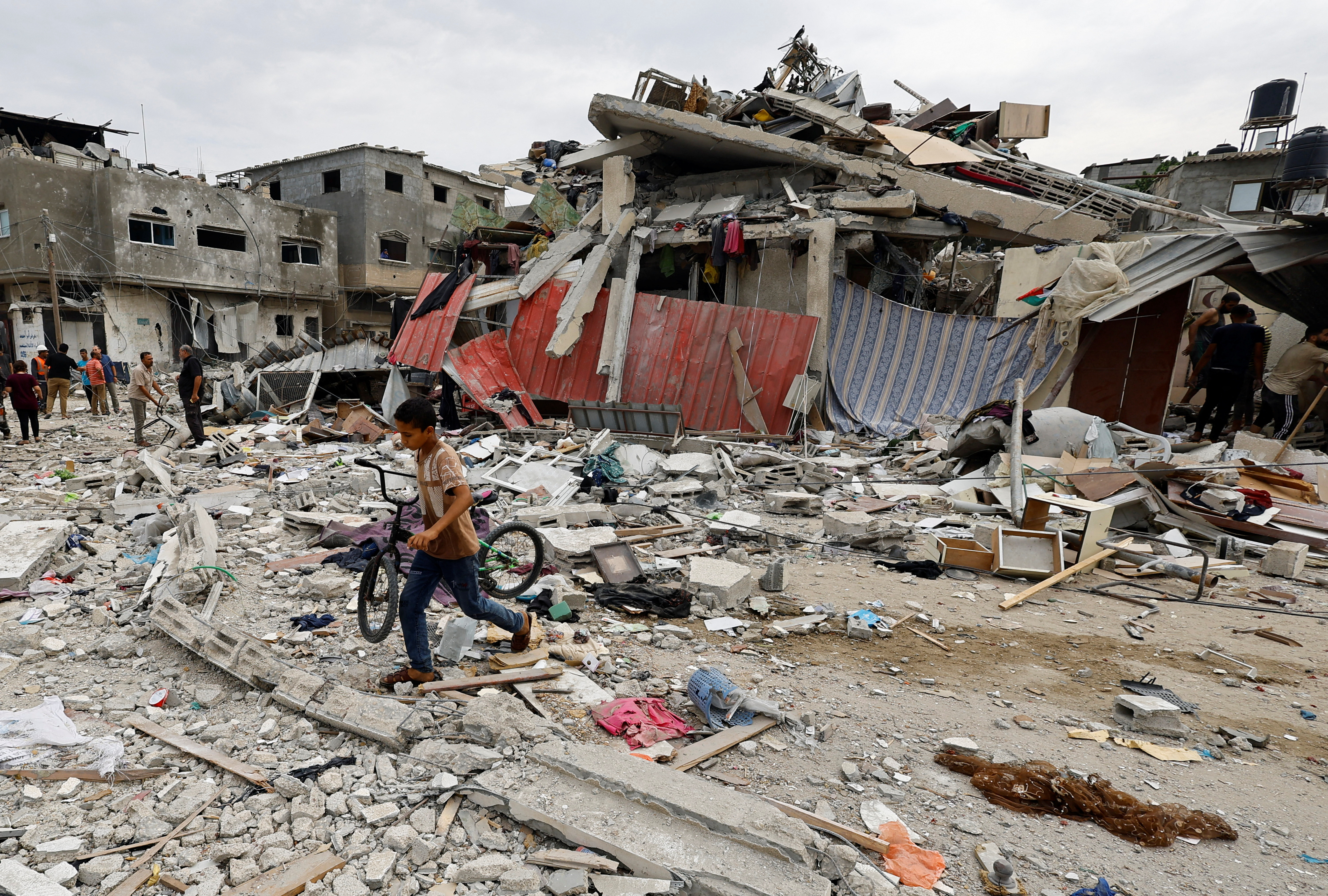A child walks at the site of an Israeli air strike on a house,