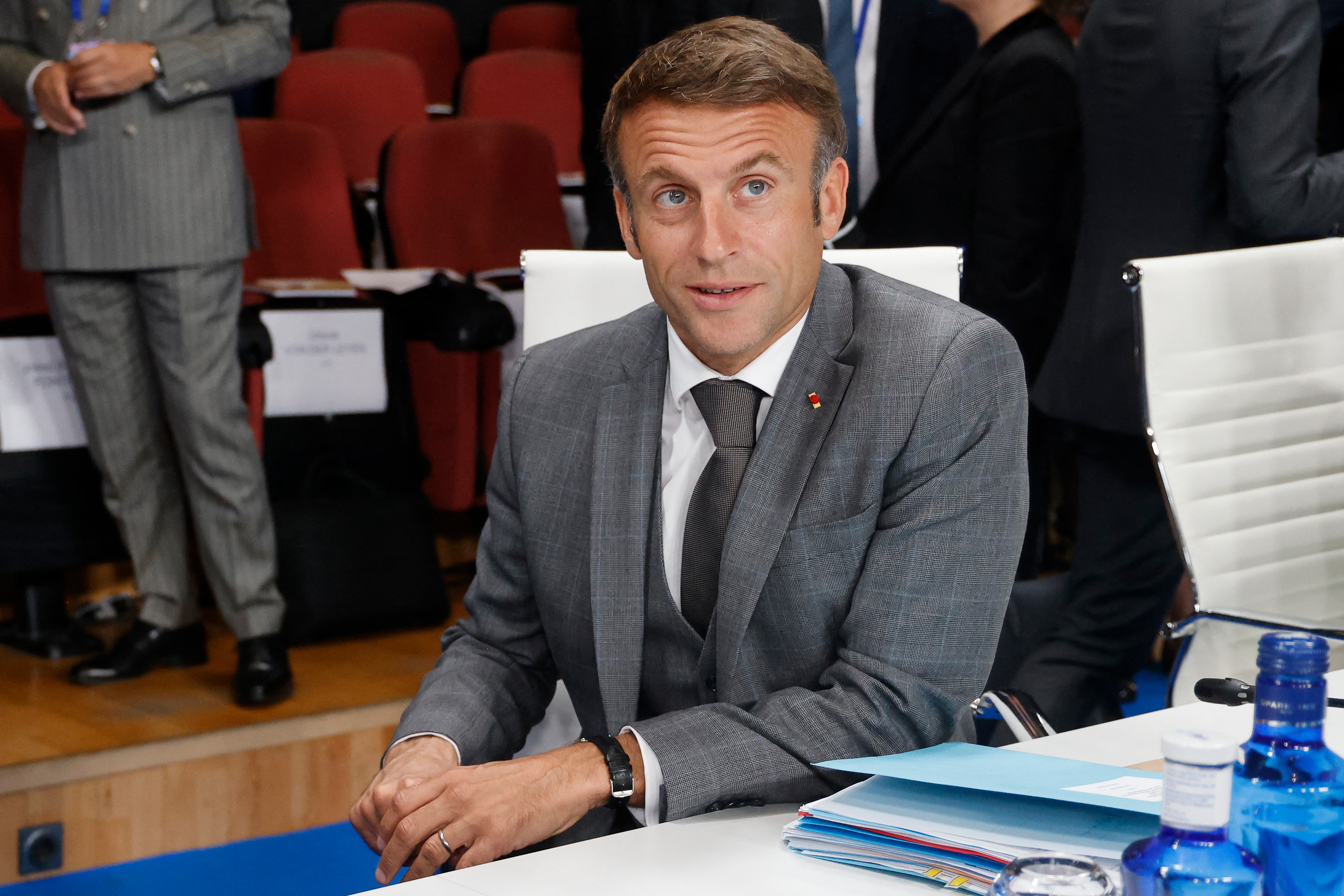 President Macron of France sits at a table souring plenary session in the EU.
