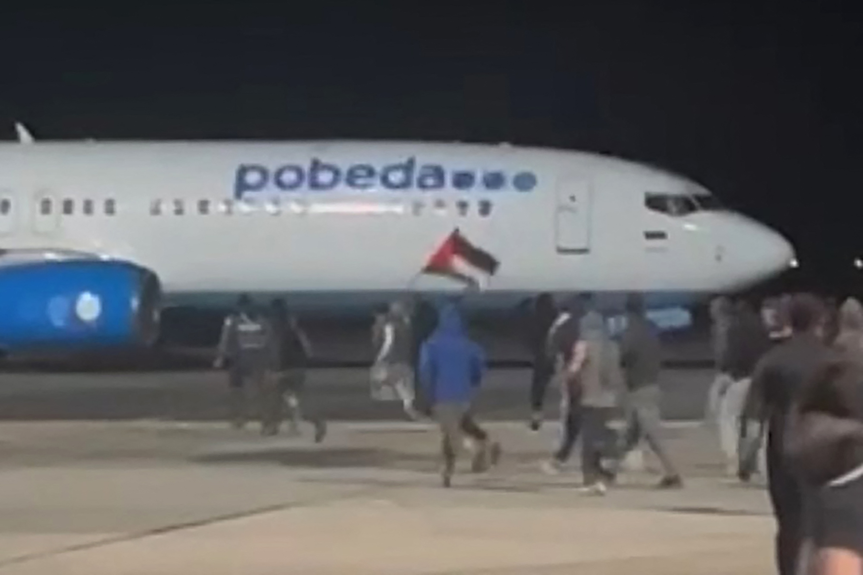 This frame grab taken from video footage posted on the Telegram channel @askrasul on October 29, 2023 shows protestors on the apron area of an airport in Makhachkala. - A mob looking for Israelis and Jews overran an airport in Russia's Caucasus republic of Dagestan on October 29, after rumours spread that a flight was arriving from Israel. (Photo by Telegram / @askrasul / AFP) / RESTRICTED TO EDITORIAL USE - MANDATORY CREDIT "AFP PHOTO / TELEGRAM CHANNEL @ASKRASUL" - NO MARKETING NO ADVERTISING CAMPAIGNS - DISTRIBUTED AS A SERVICE TO CLIENTS - RESTRICTED TO EDITORIAL USE - MANDATORY CREDIT "AFP PHOTO / Telegram channel @askrasul" - NO MARKETING NO ADVERTISING CAMPAIGNS - DISTRIBUTED AS A SERVICE TO CLIENTS /