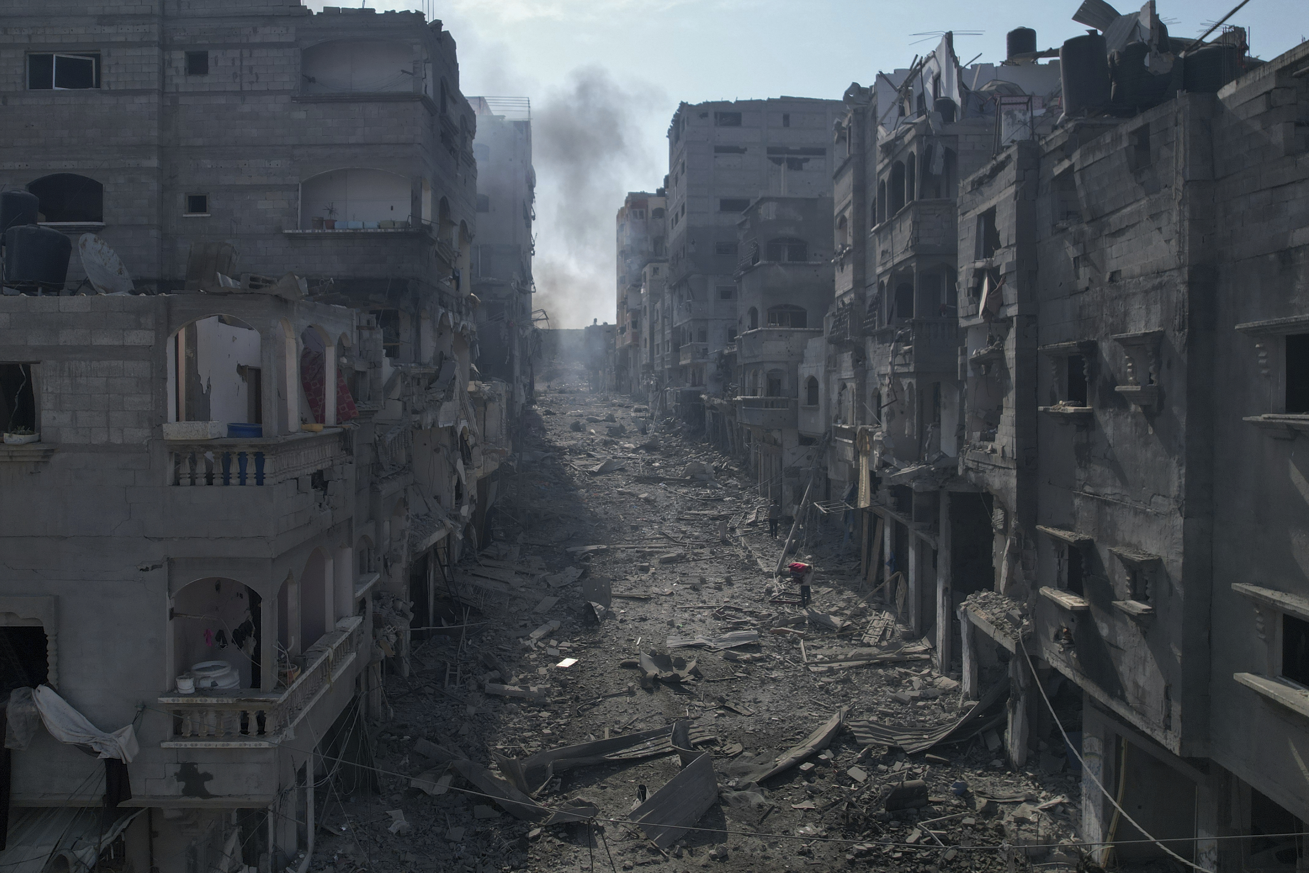 Rubble litters a street between smoldering buildings hit by an Israeli airstrike in Jabaliya
