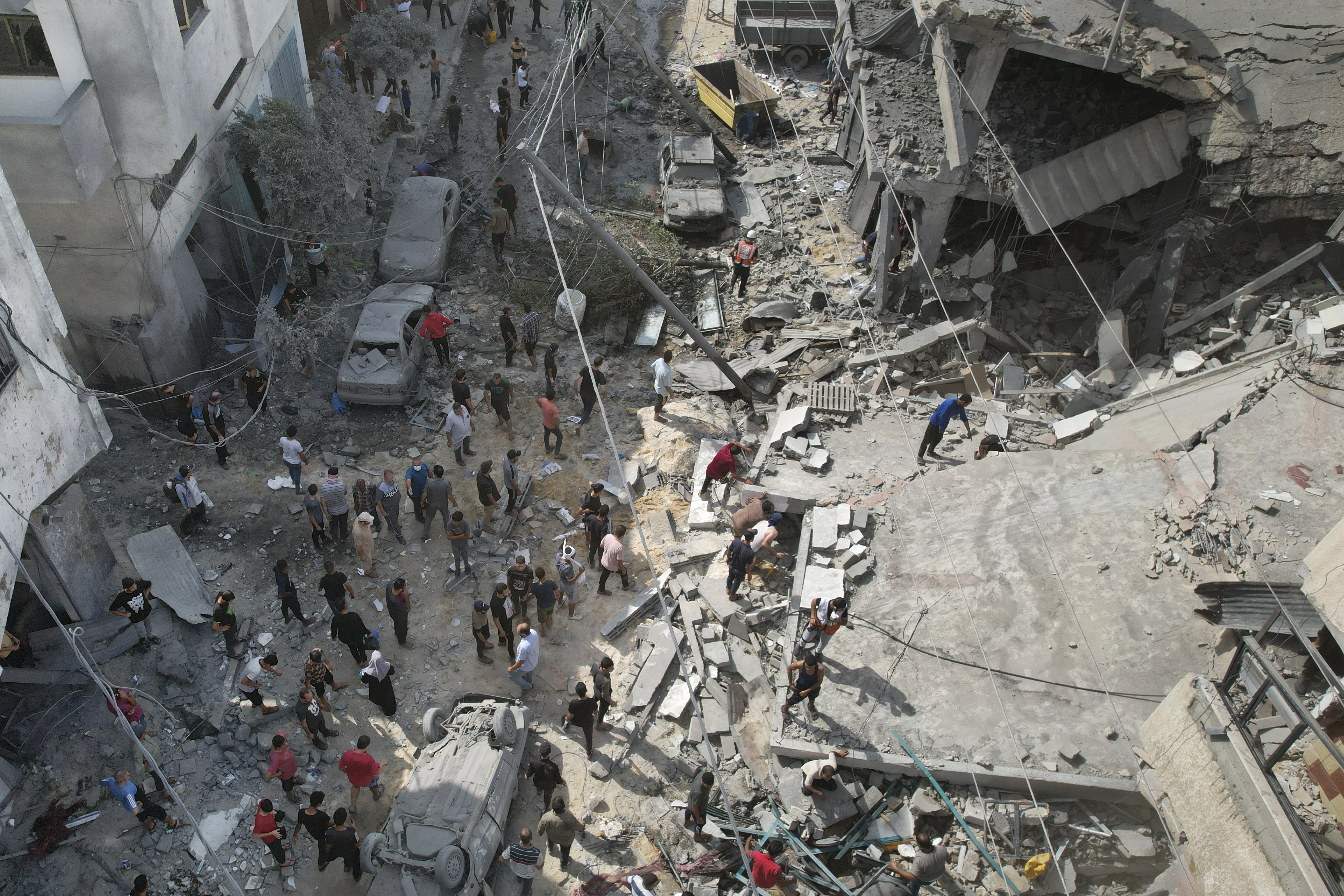 Palestinians look for survivors after the Israeli bombardment of the Gaza Strip in Deir Al-Balah