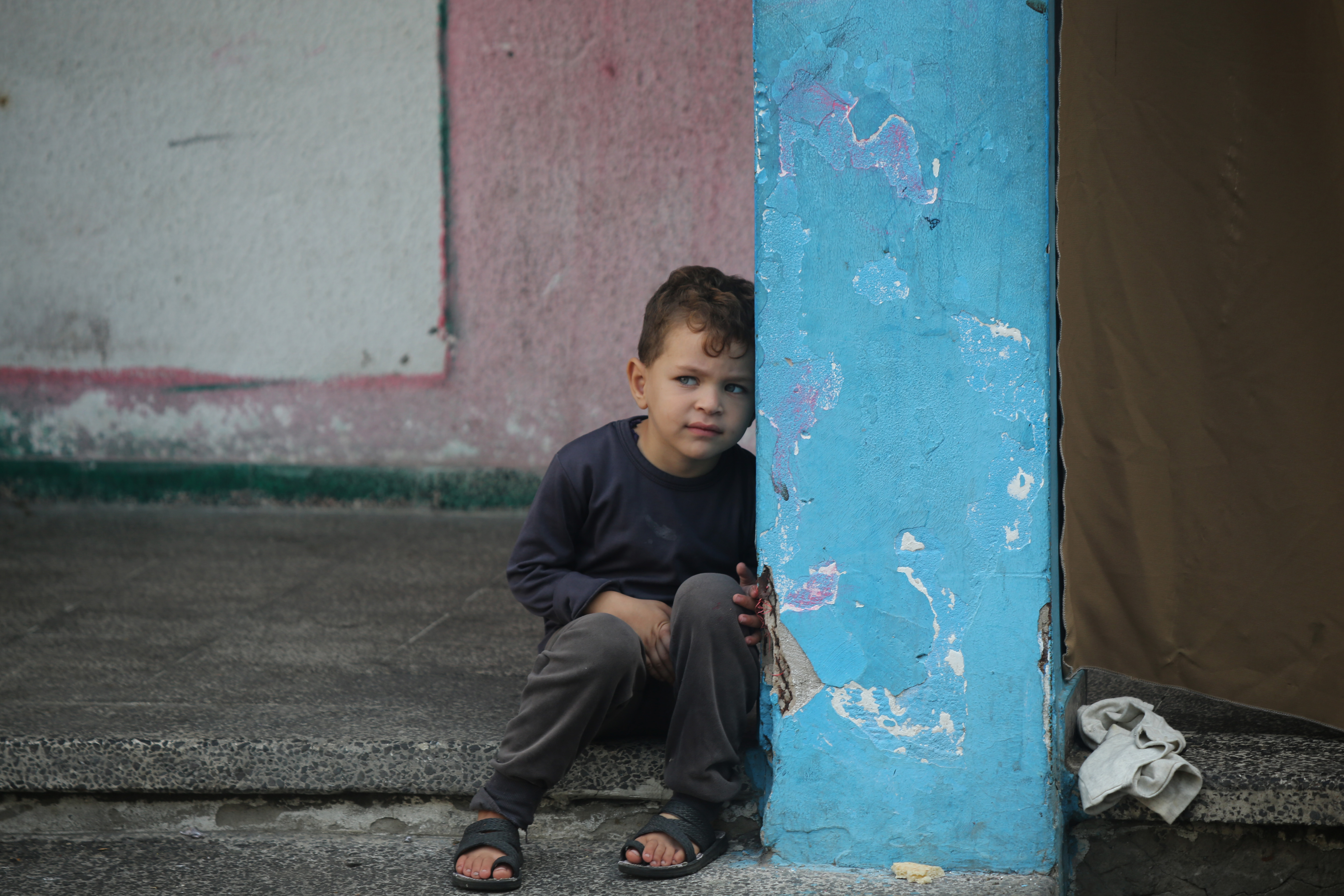 Displaced Palestinian citizens gather at the UNRWA (The United Nations Relief and Works Agency for Palestine Refugees) Beach School